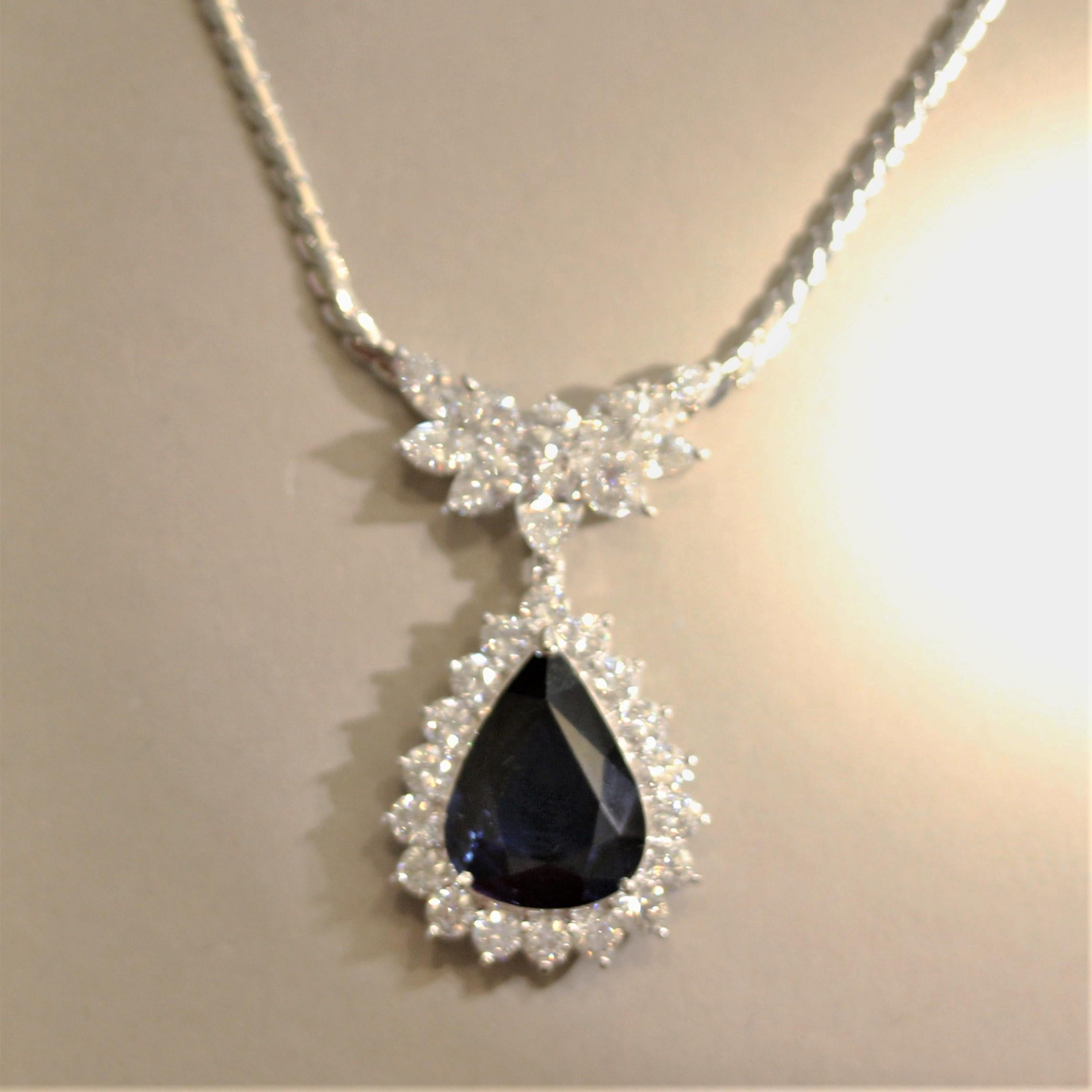 A large and impressive sapphire drop necklace! It features a 9.41 carat pear-shape sapphire with a rich even blue color. It is surrounded by large round brilliant-cut diamonds which weigh a total of 4.15 carats along with the diamond cluster above