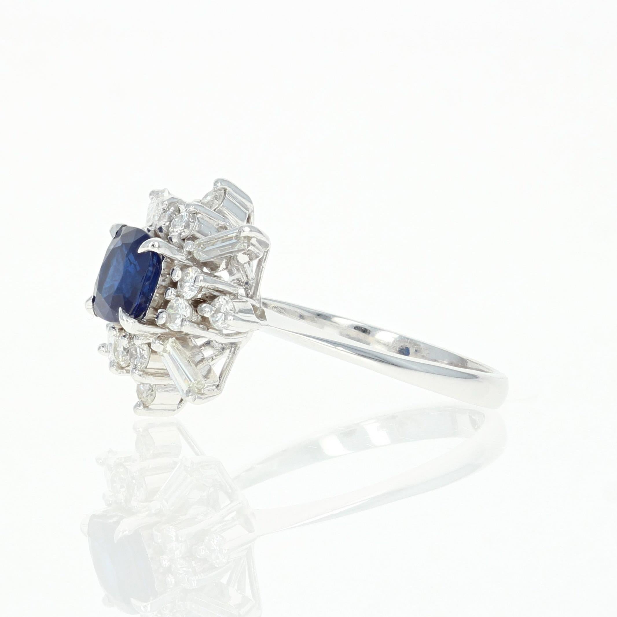Majestic and brilliant, this ring is destined to become a cherished addition to your collection of fine jewelry! This piece showcases a high quality, top color blue sapphire solitaire that is framed by a striking array of sparkling white diamonds