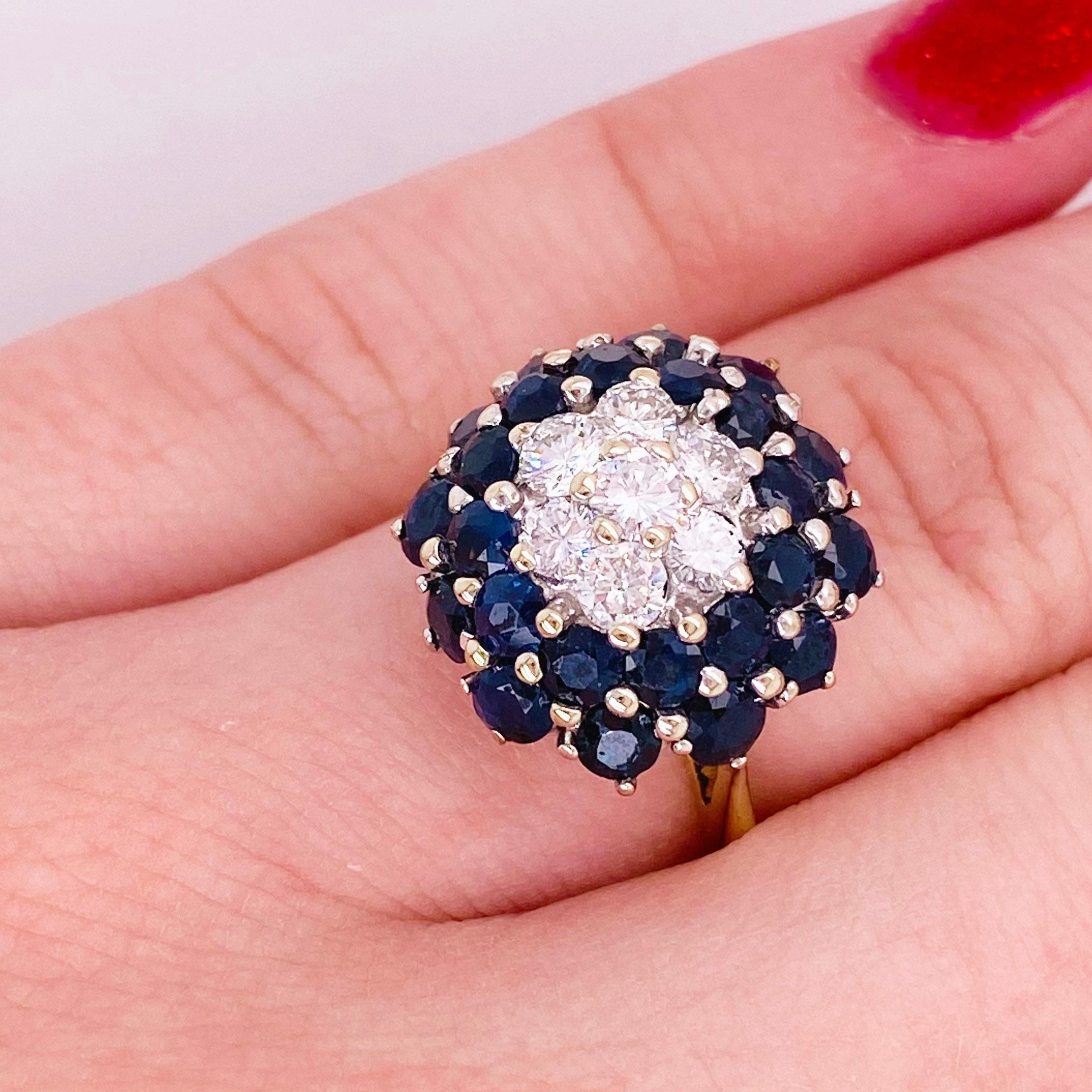 This stunningly beautiful blue sapphire and diamond cluster ring would make anyone  thrilled to receive it!  The deep blue sapphires surrounding gorgeous diamonds set in polished 14K yellow gold provides a look that is very modern and classic at the