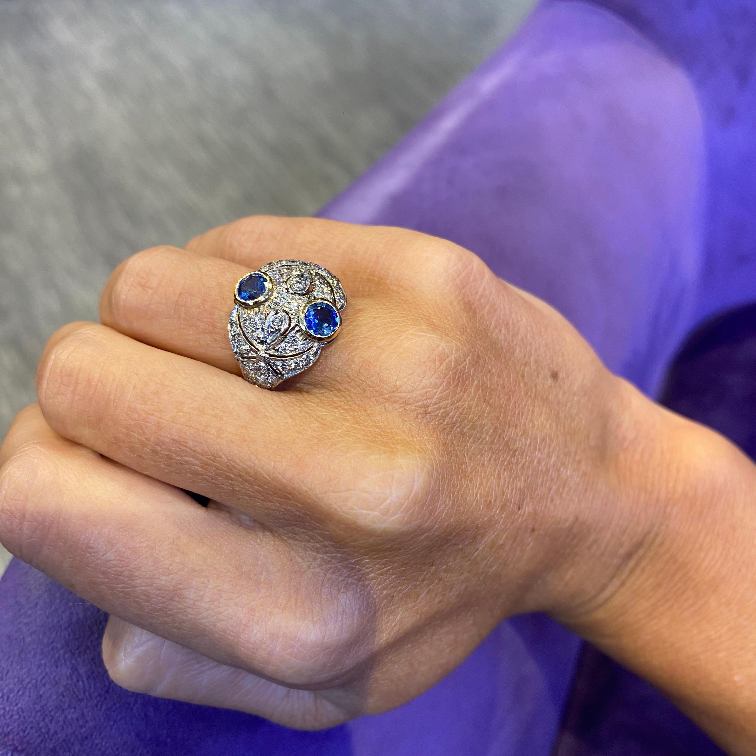 Sapphire & Diamond Ring

A ring featuring 2 bezel set sapphires with 44 round cut diamonds set in 18 karat gold 

Sapphire Weight: approximately 1.28 carats 
Diamond Weight: approximately .60 carats

Ring Size: 7.5

Complimentary Resizing 
