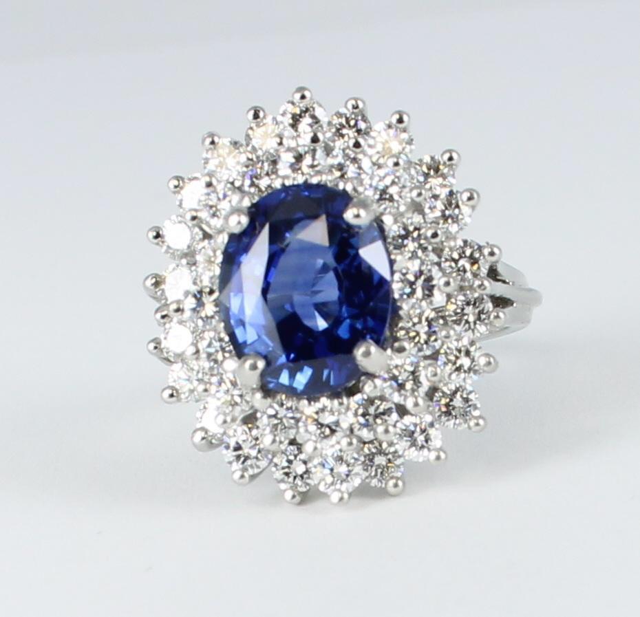 This platinum sapphire and diamond ring will turn heads.  A gorgeous 4.03 carat total weight blue oval sapphire is set in the center of this elegant ring and is surrounded by two descending rows of diamonds, 1.70 carat total weight.  The ring is .75