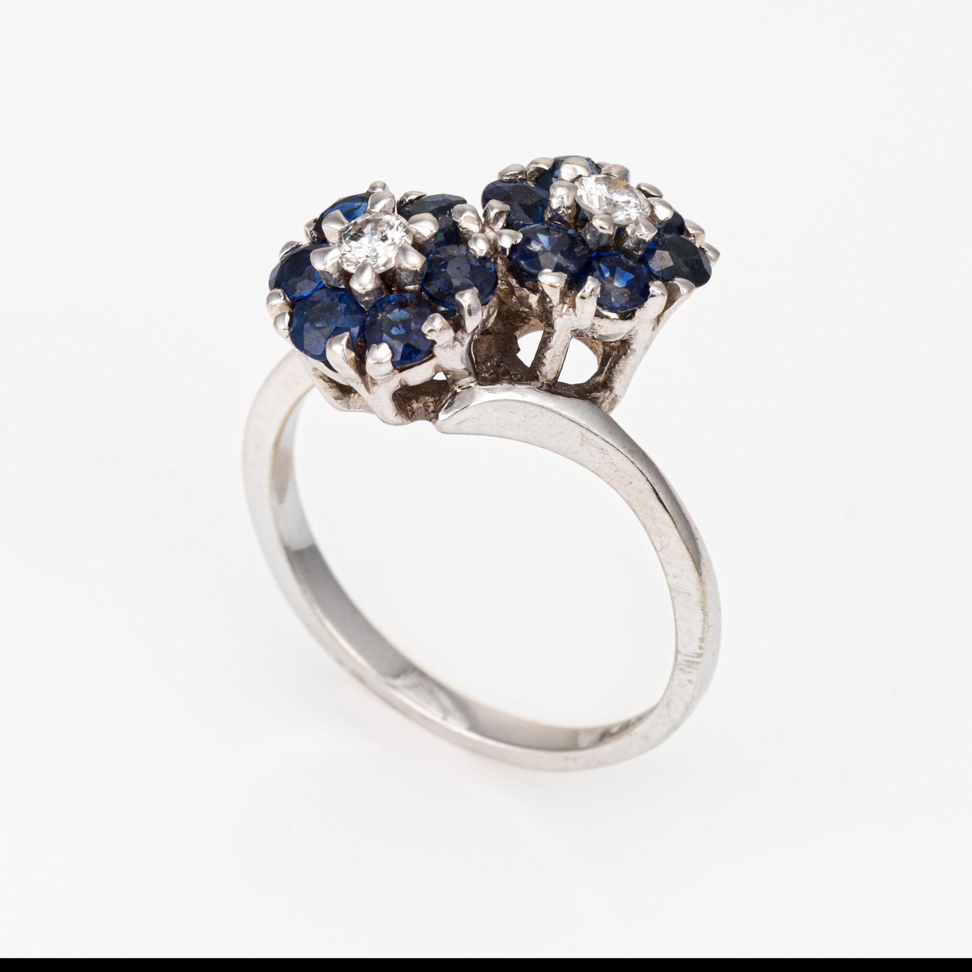Finely detailed vintage sapphire & diamond 'moi et toi' cluster ring crafted in 14k white gold (circa 1960s to 1970s). 

Two estimated 0.08 carat diamonds and 12 estimated 0.07 carat blue sapphires are set into the mounts. The total sapphire weight