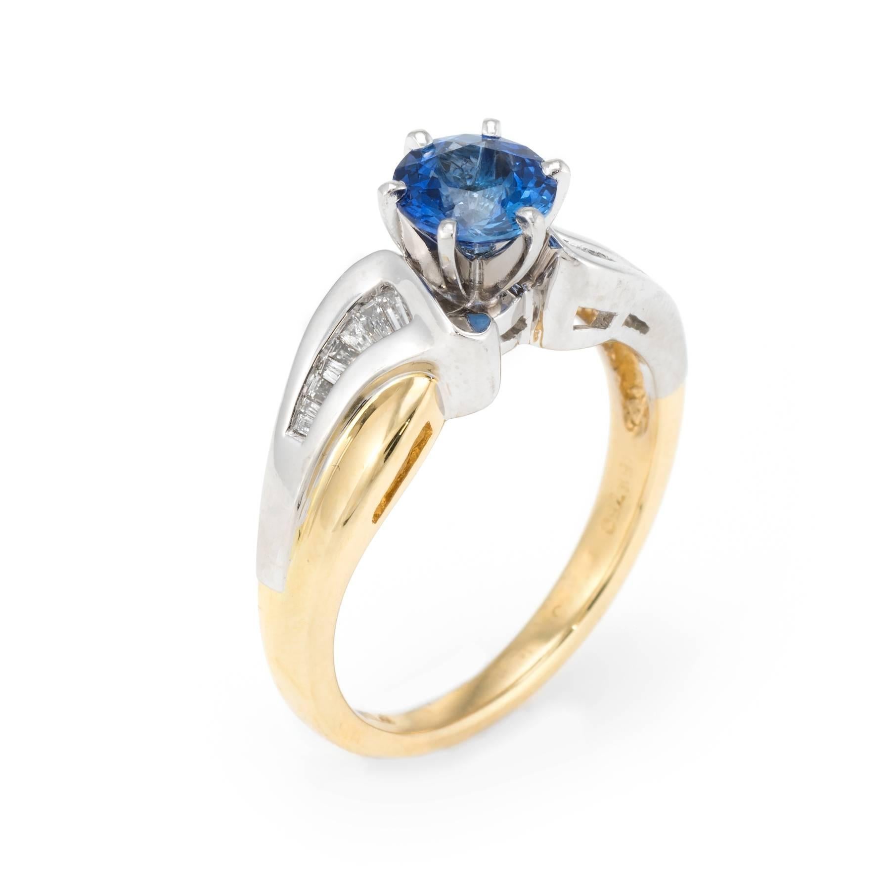 Finely detailed vintage ring, crafted in 18 karat yellow gold and 950 platinum. 

Faceted round cut sapphire measures 6mm (estimated at 0.90 carats), accented with an estimated 0.25 carats of baguette cut diamonds (estimated at G color and VS2