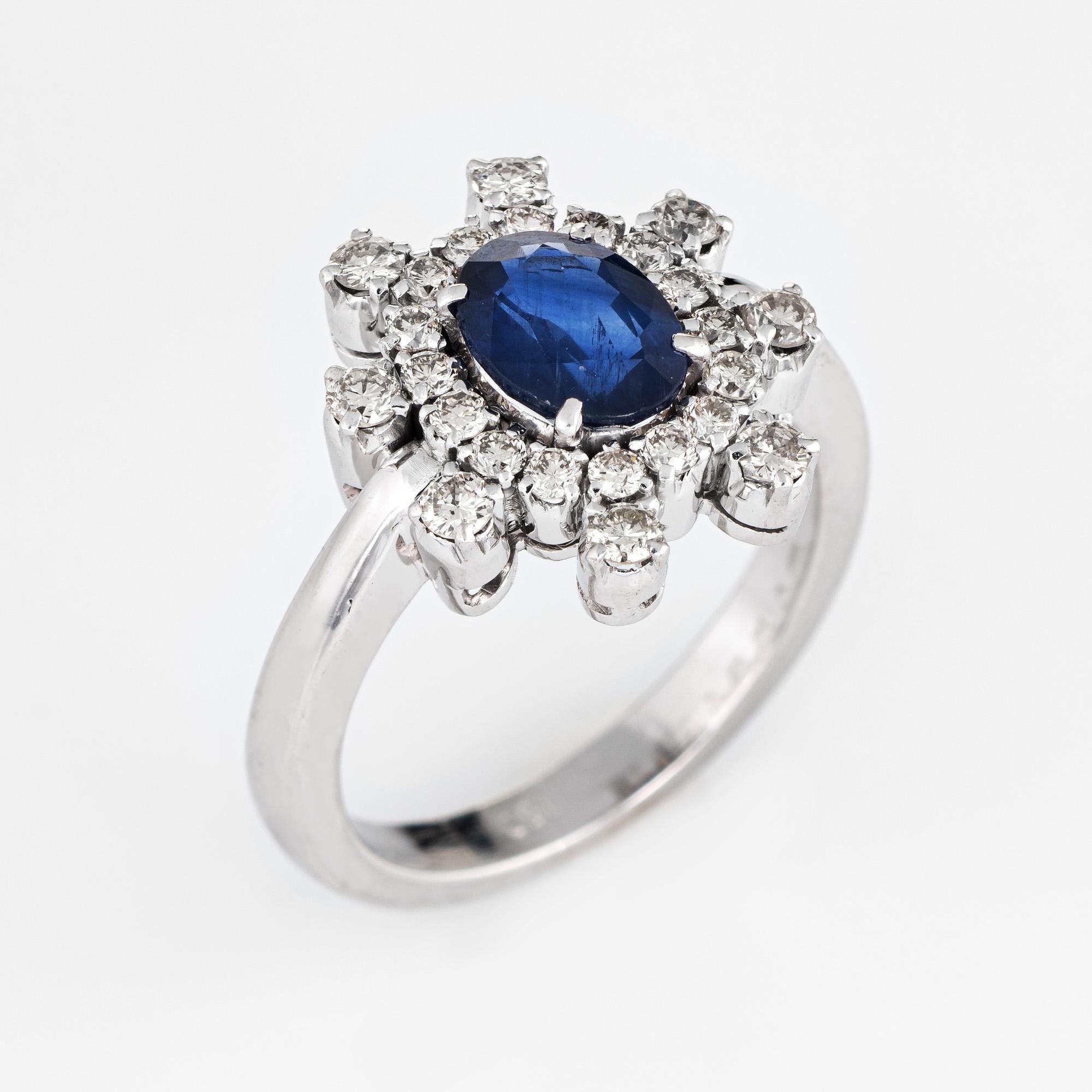 Stylish vintage diamond & sapphire cocktail ring (circa 1970s to 1980s) crafted in 18 karat white gold. 

Faceted oval sapphire measures 8mm x 6mm (estimated at 1.75 carats), accented with an estimated 0.64 carats of diamonds (estimated at I-J color