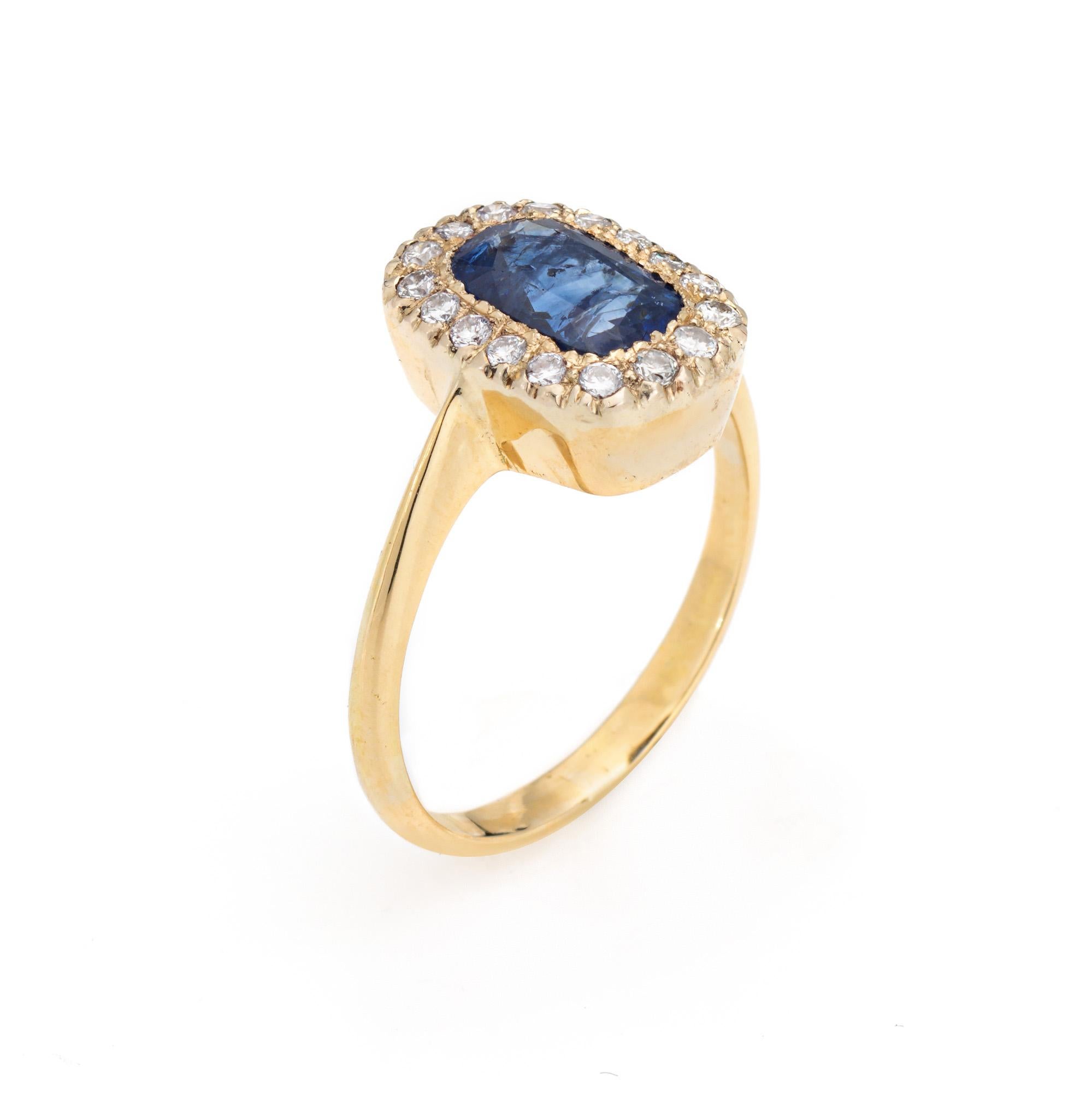 Stylish and finely detailed sapphire & diamond ring crafted in 18k yellow gold (circa 1970s to 1980s).

Center set sapphire measures 8mm x 5mm (estimated at 1.75 carats). 17 round brilliant cut diamonds total an estimated 0.34 carats (estimated at
