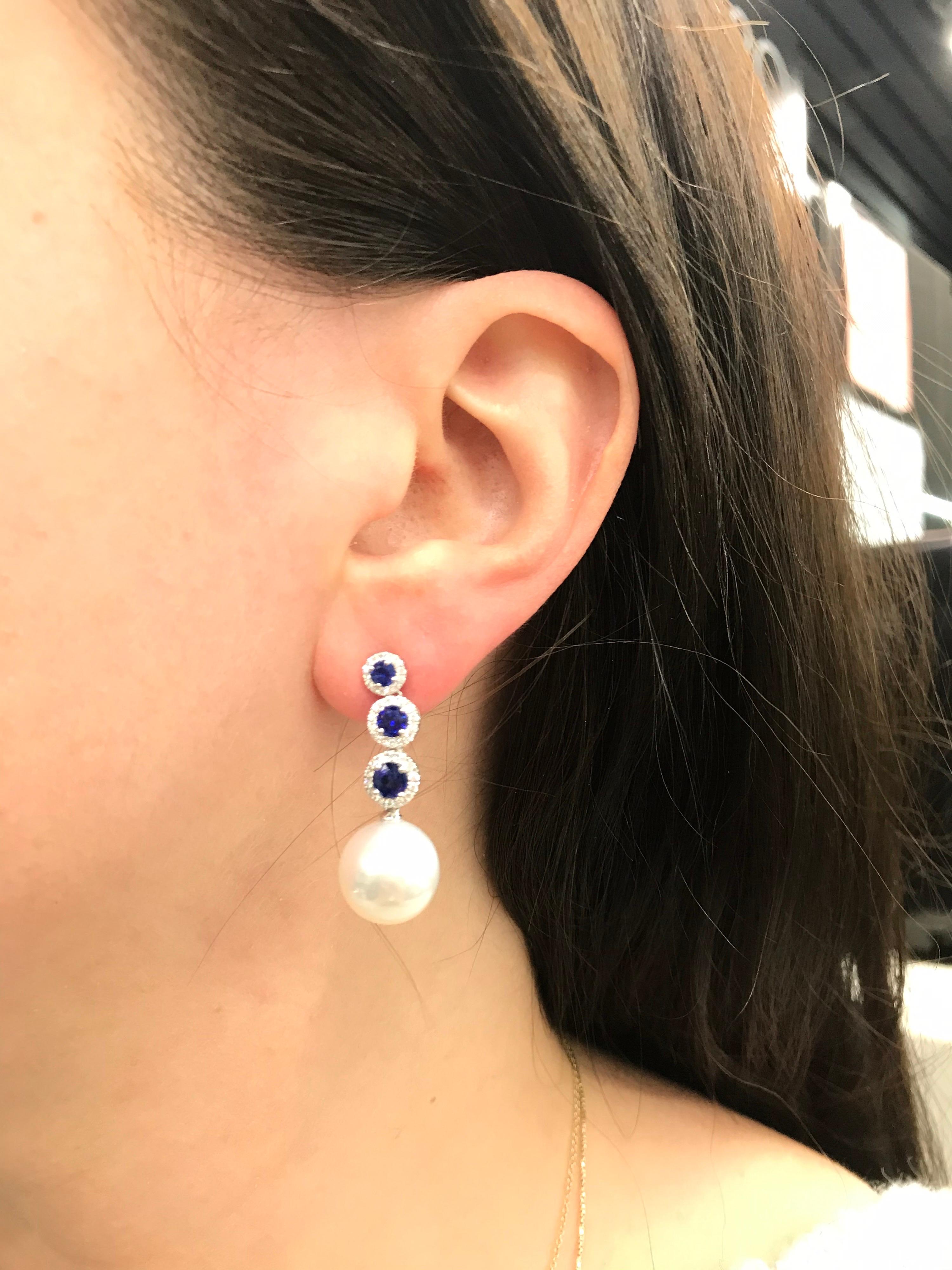 18K White gold drop earrings featuring 6 blue sapphires, 1.50 carats, flanked with round brilliants weighing 0.37 carats and two South Sea Pearls measuring 12-13 mm
Color G-H
Clarity SI