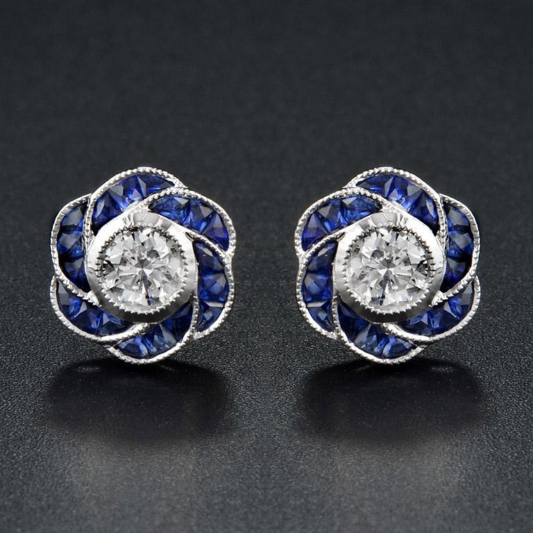 Perfect with everyday wear, these charming vintage Art Deco revivalist design stud earrings feature a pair of brilliant-cut diamonds surrounded by bright blue sapphire for rose petals finished look all in 18K white gold.

Information
Style: