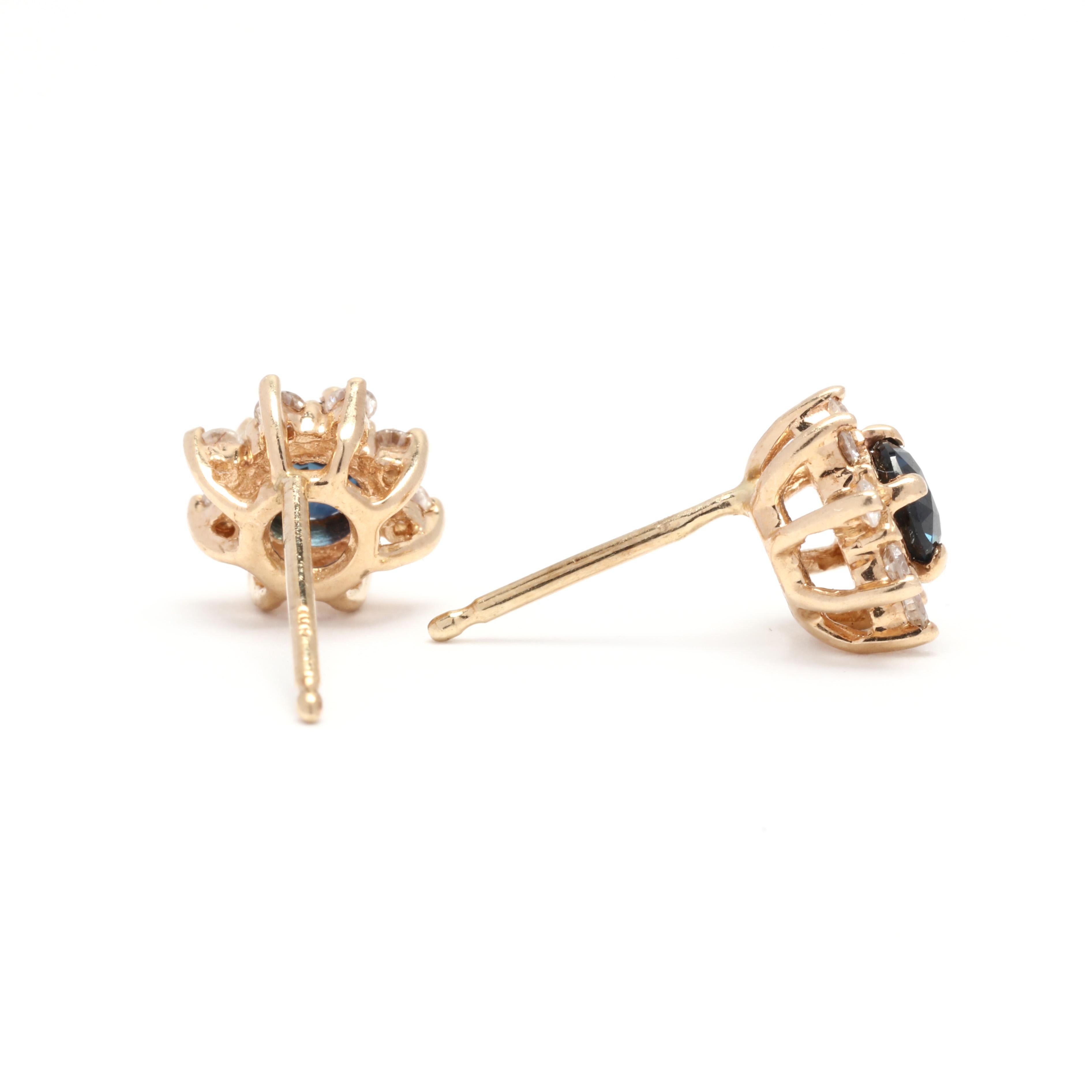 A pair of 14 karat yellow gold sapphire and diamond stud earrings. These earrings feature prong set round cut sapphires weighing approximately .50 total carats surrounded by a halo of full cut round diamonds weighing approximately .20 total carats