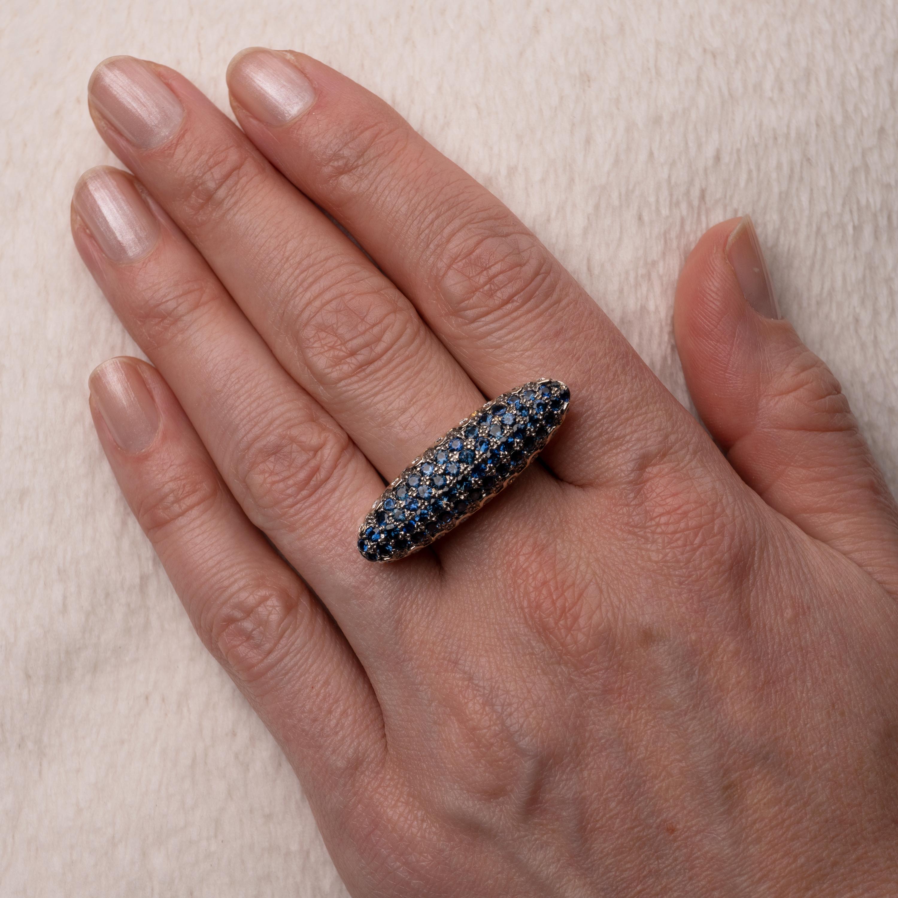 This outrageously good Sapphire & Diamonds torpedo-shaped ring sits horizontally on and spans across almost three fingers!

This fabulous and extremely eye-catching cocktail statement ring is crafted in 18 karat gold and adorned with 54 round-cut