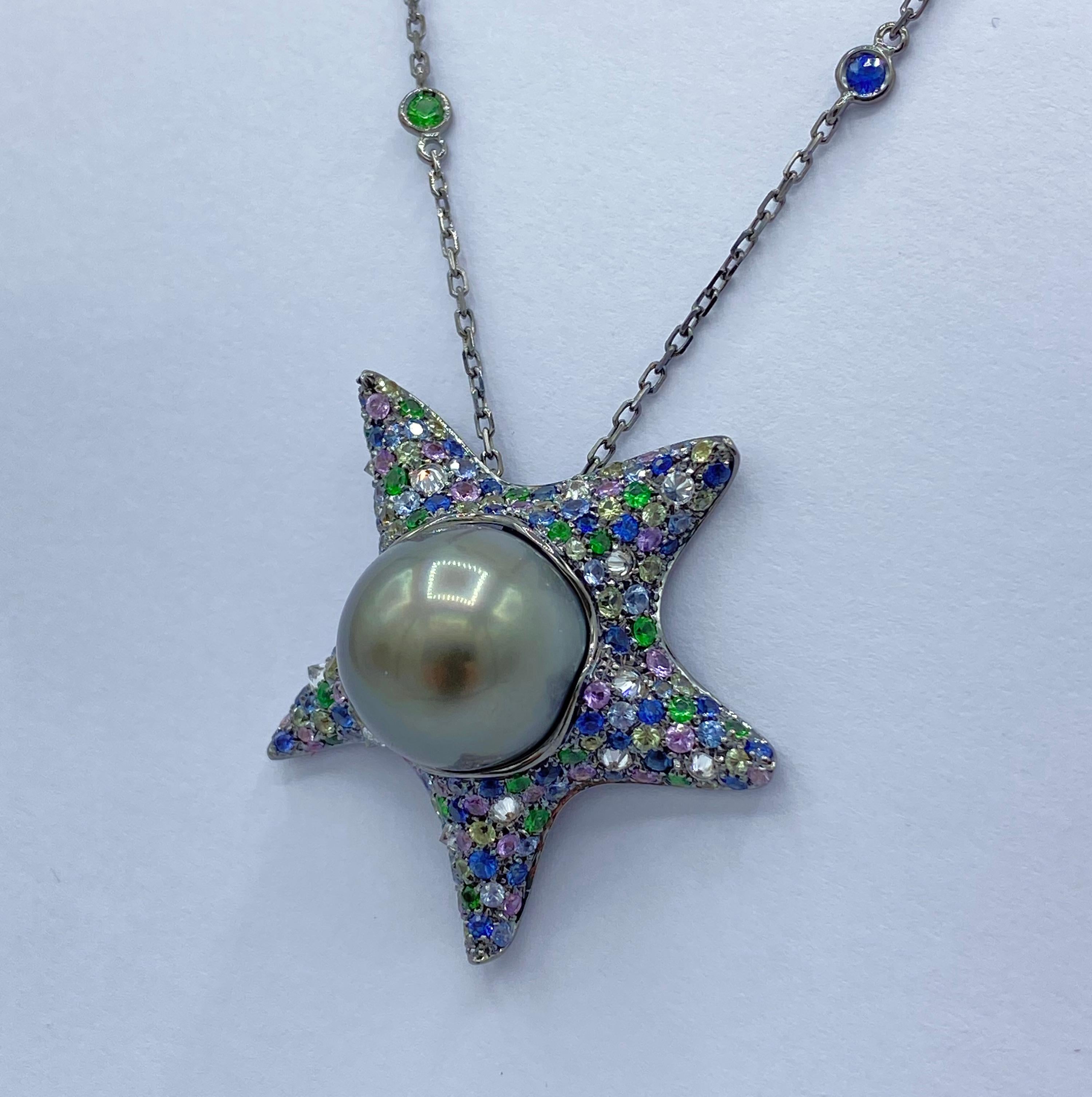Multicolor Sapphire Diamond Tahitian Pearl 18Kt Gold Starfish Pendant Made in Italy
This pendant is a starfish covered by many green, lilacs, two kinds of blue sapphires and tsavorites; white diamonds set in the opposite way and a Tahiti pearl