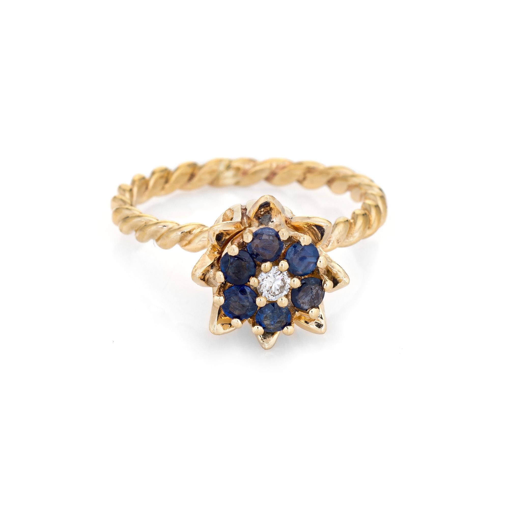 Stylish vintage sapphire & diamond tulip ring (circa 1960s to 1970s) crafted in 14 karat yellow gold. 

Round brilliant cut diamond is estimated 0.03 carats (estimated at G-H color and VS2 clarity). Six sapphires total an estimated 0.35 carats. The