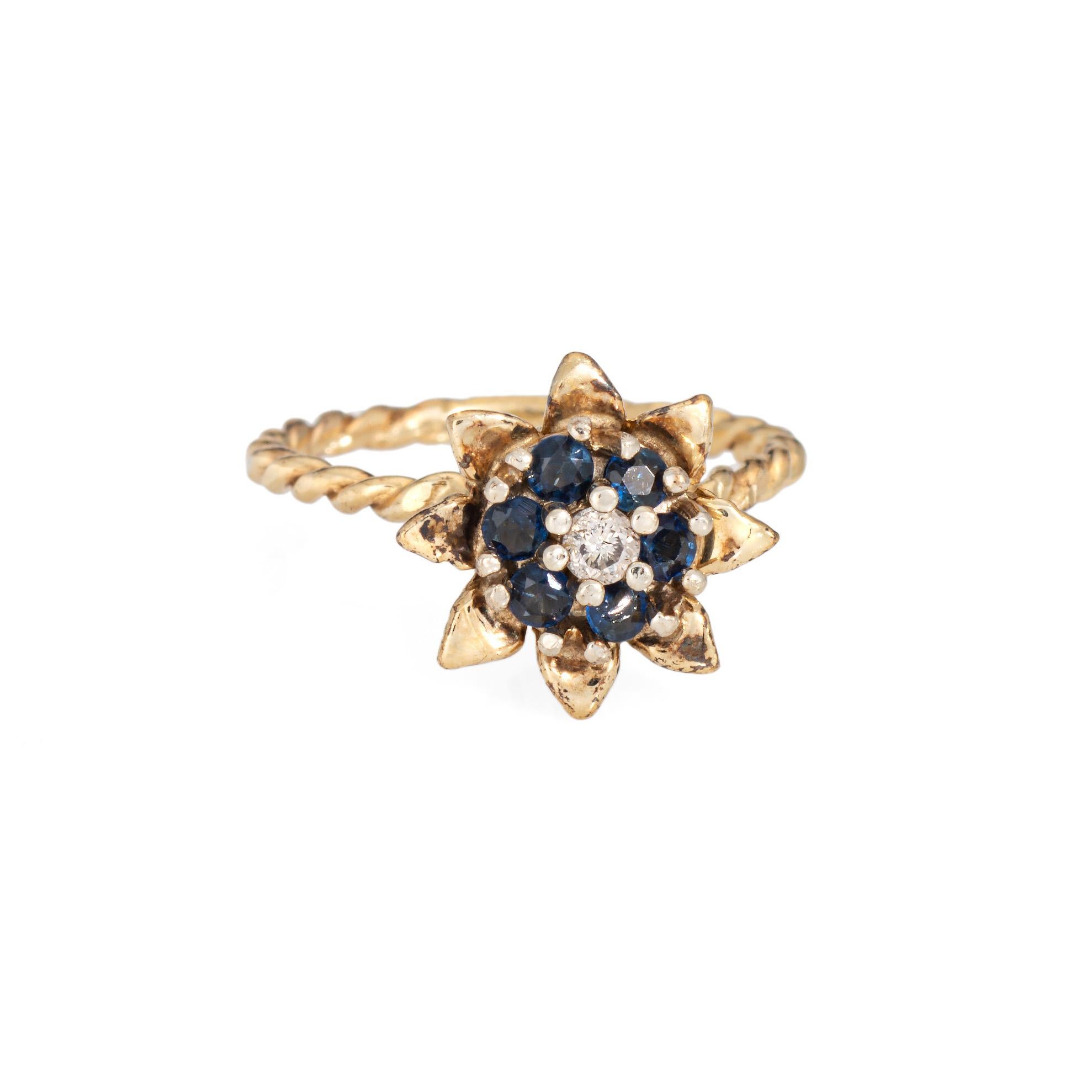 Stylish vintage sapphire & diamond tulip ring (circa 1960s to 1970s) crafted in 14 karat yellow gold. 

Round brilliant cut diamond is estimated 0.03 carats (estimated at L-M color and I1 clarity). Six sapphires measure approx. 2mm each. The