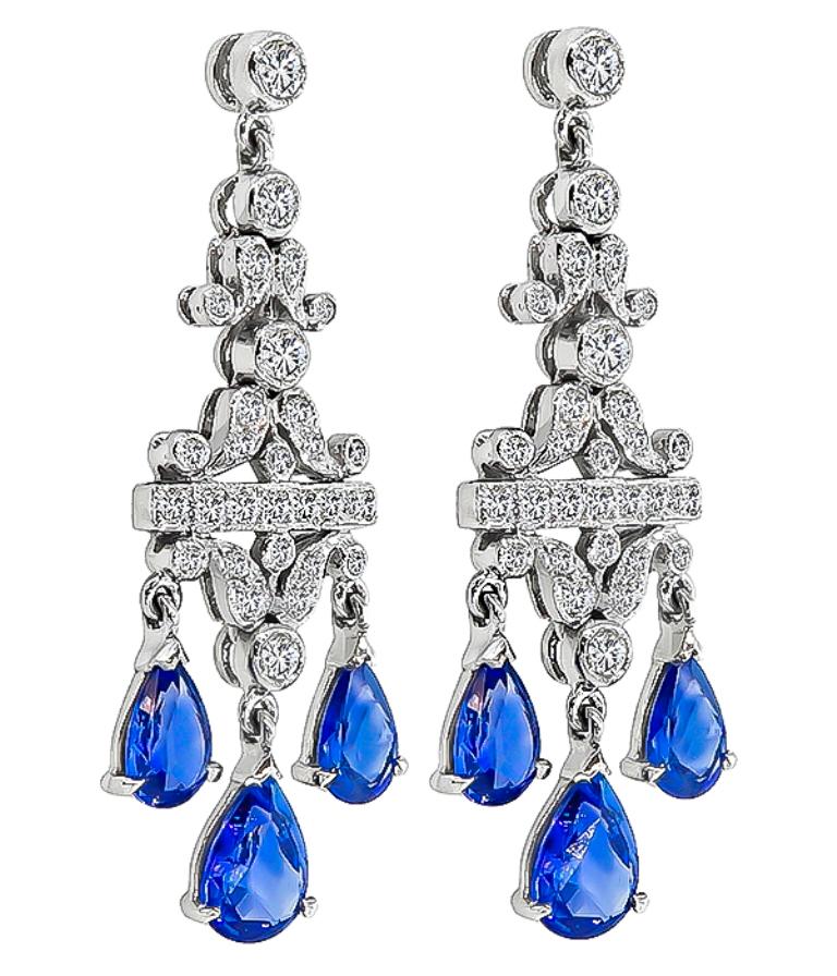 This gorgeous pair of 14k white gold sapphire diamond chandelier earrings feature lovely pear shape sapphires that weigh approximately 3.00ct. The sapphires are accentuated by round cut diamonds that weigh approximately 1.00ct. graded H color with