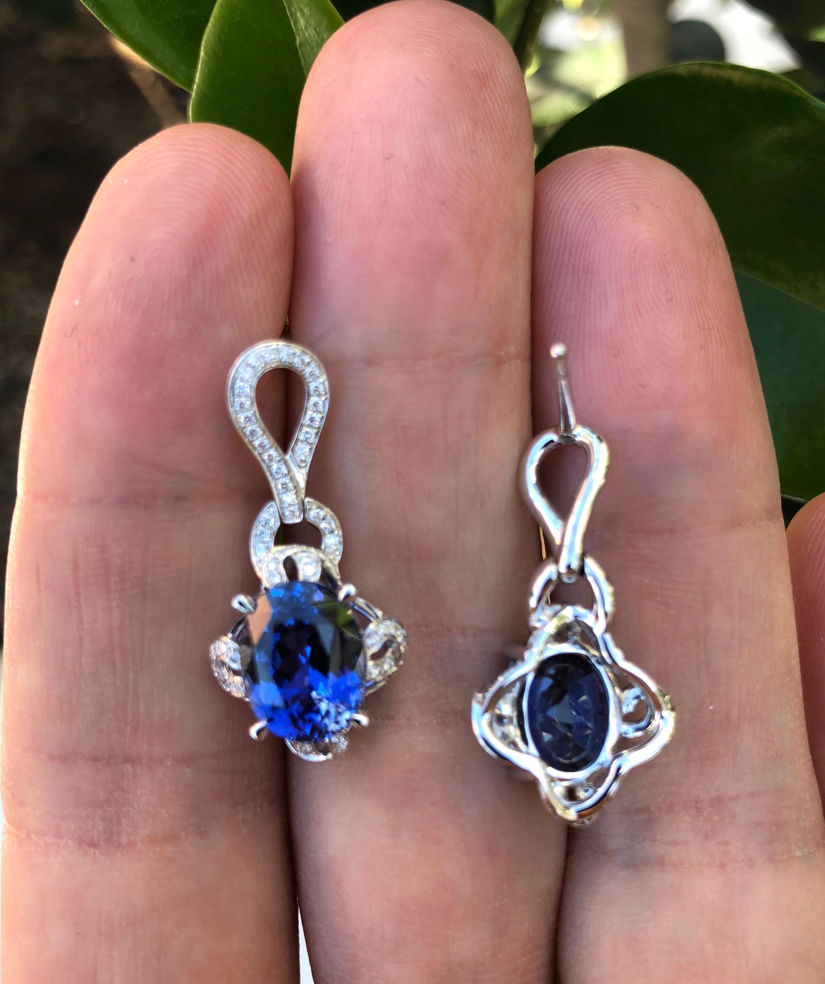 Sapphire earrings showcasing a gorgeous pair of oval blue Sapphires weighing a total of 7.34 carats, and a total of 0.38 carat round brilliant diamonds
Length: 1 inch long.
Returns are accepted and paid by us within 7 days of delivery. 

Colorful