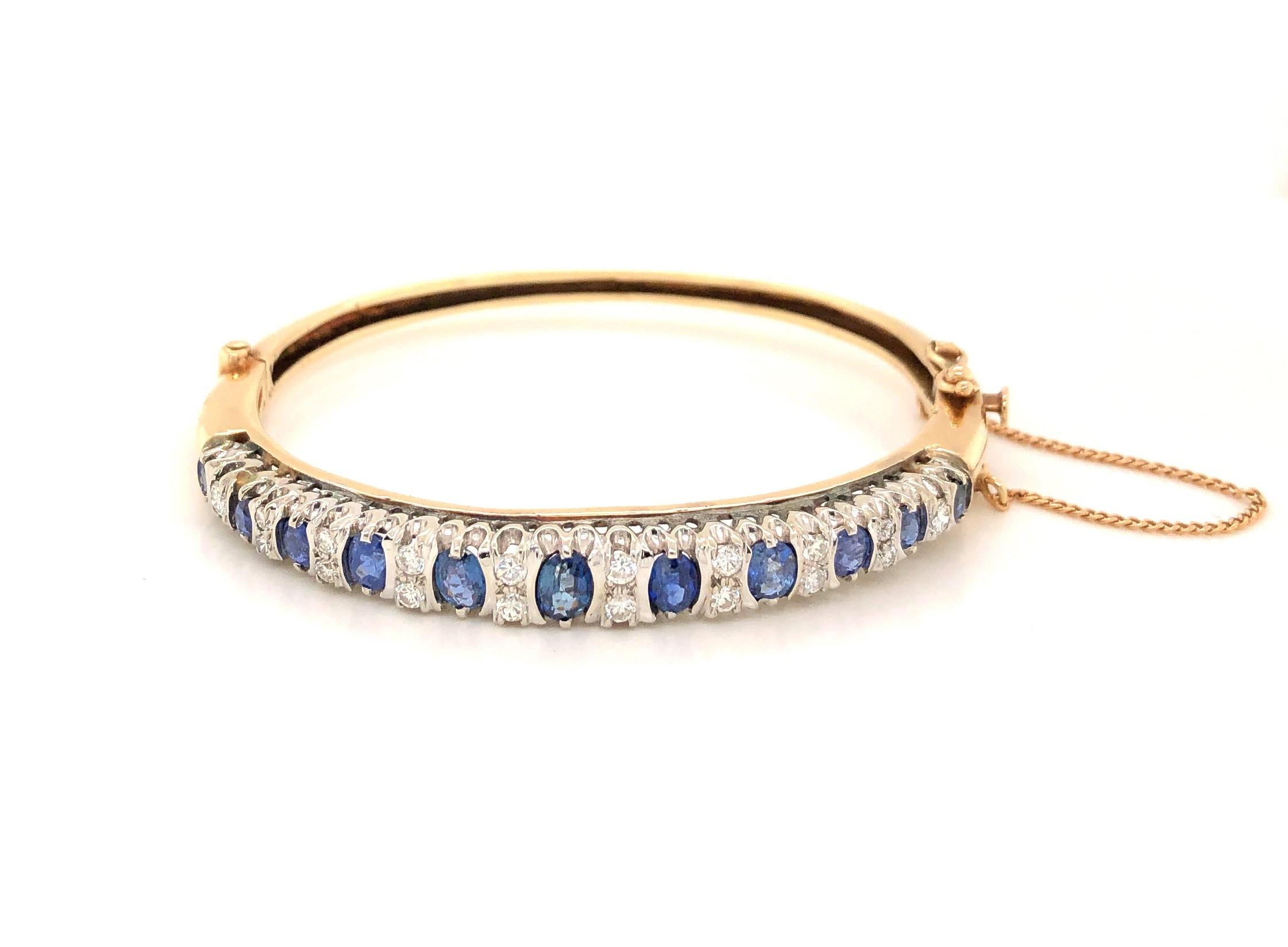 Over a half carat of oval facet cut vibrant blue natural sapphire complemented by eighteen individually set sparking round white faceted diamonds, with a total weight of .44 carats. create an exciting display as they graduate along the front of this