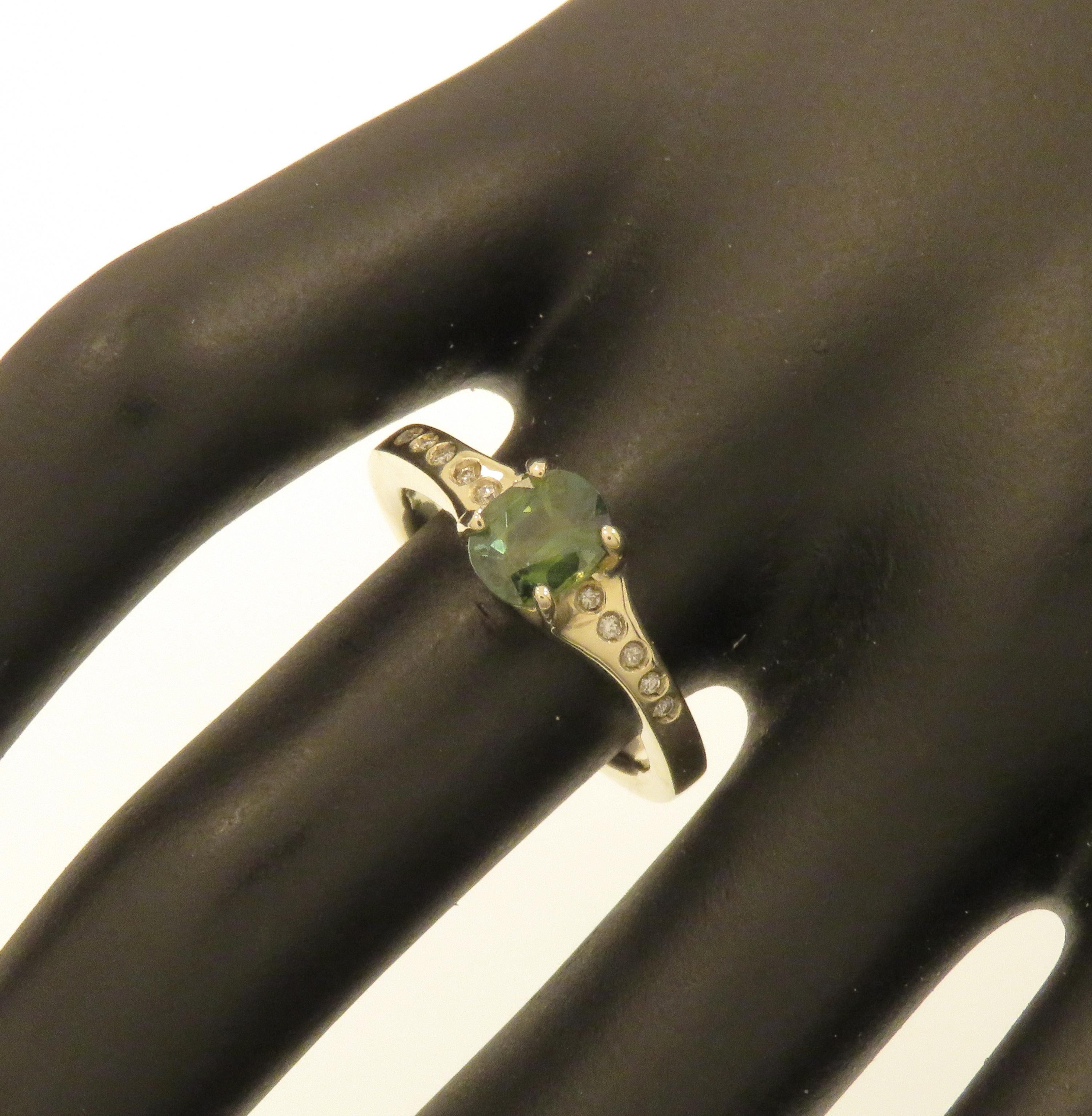 Stunning solitaire ring featuring a natural green sapphire oval cut and 10 diamonds on the ring shoulders. Handmade in 9k white gold. Marked with the Italian gold mark 375 and Botta Gioielli brandmark 716MI.

Handcrafted in: 9k white gold.
1 natural