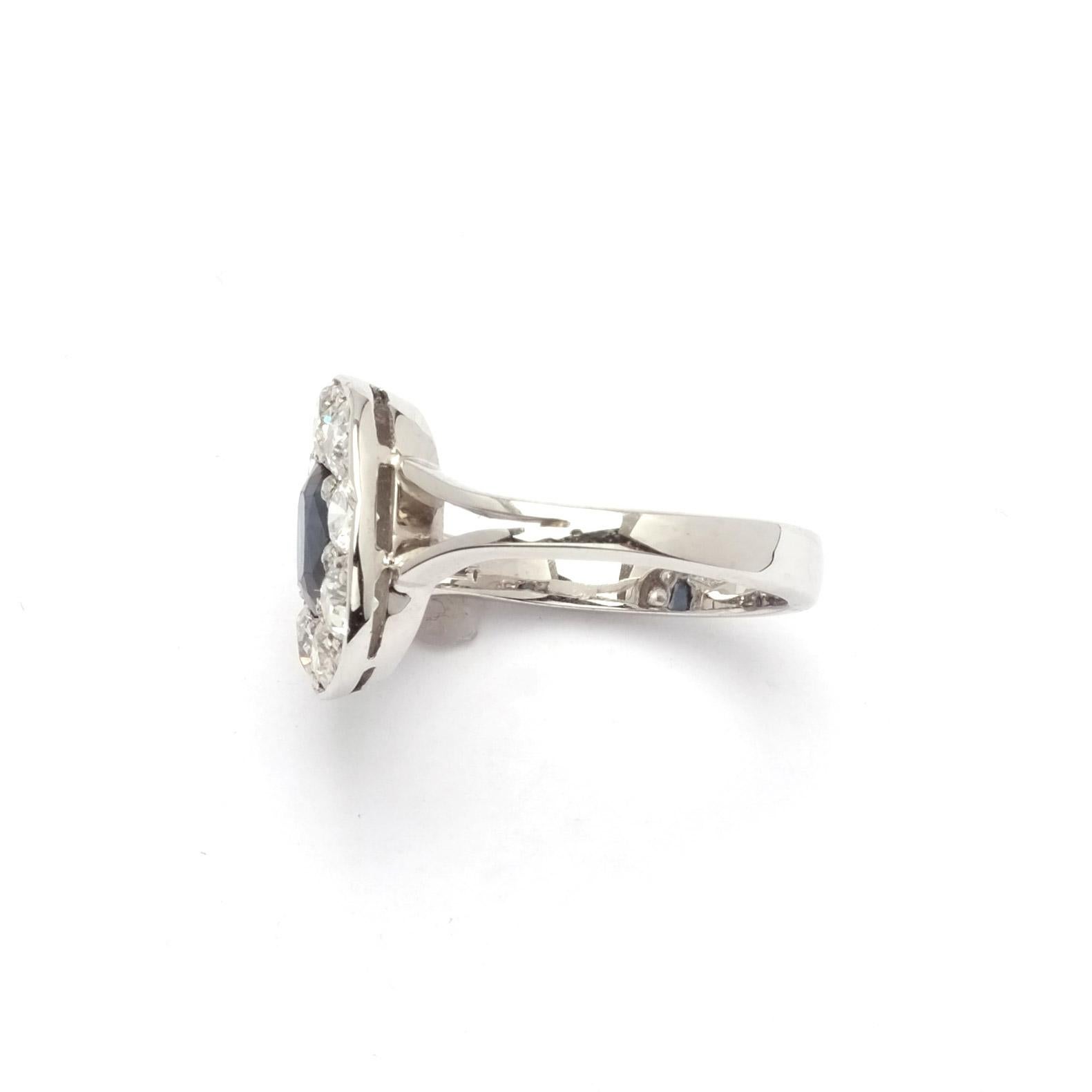 Oval cut sapphire ring set in 18ct gold and round cut diamonds of around 15 points each.

Highlights
- 18ct white gold
- Oval cut sapphire
- Round cut diamonds 1.2ct

Measurements
- Diameter 1.4cm
- Weight 5.04g
- Size ITA 12 (in can be resized)