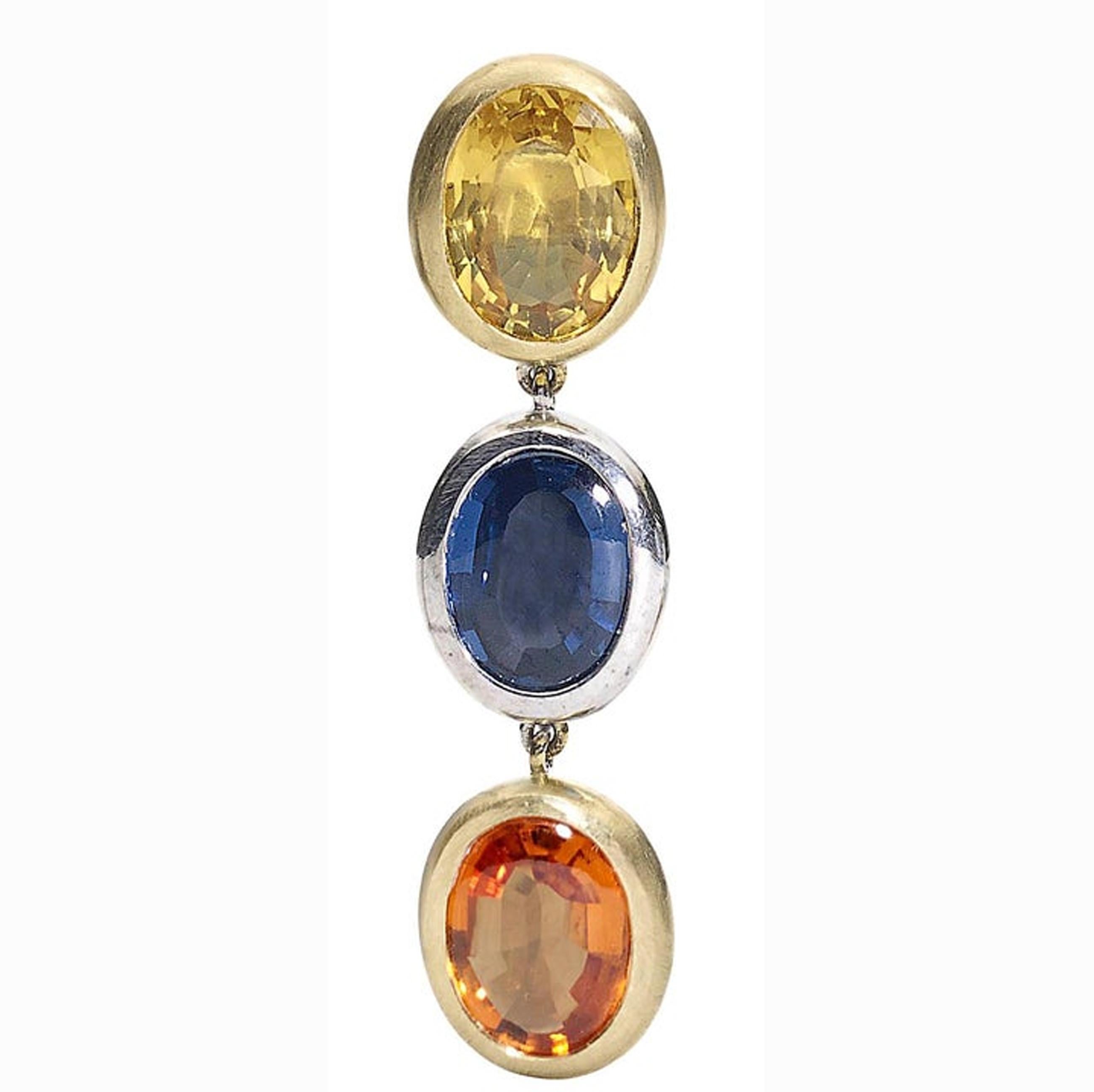 Elegant and striking drop earrings comprising three oval sapphires, in yellow, blue and orange - table top cut, set in 18ct yellow and 18ct white golds. These earrings have been made by hand in the London studio of Julia Lloyd George
