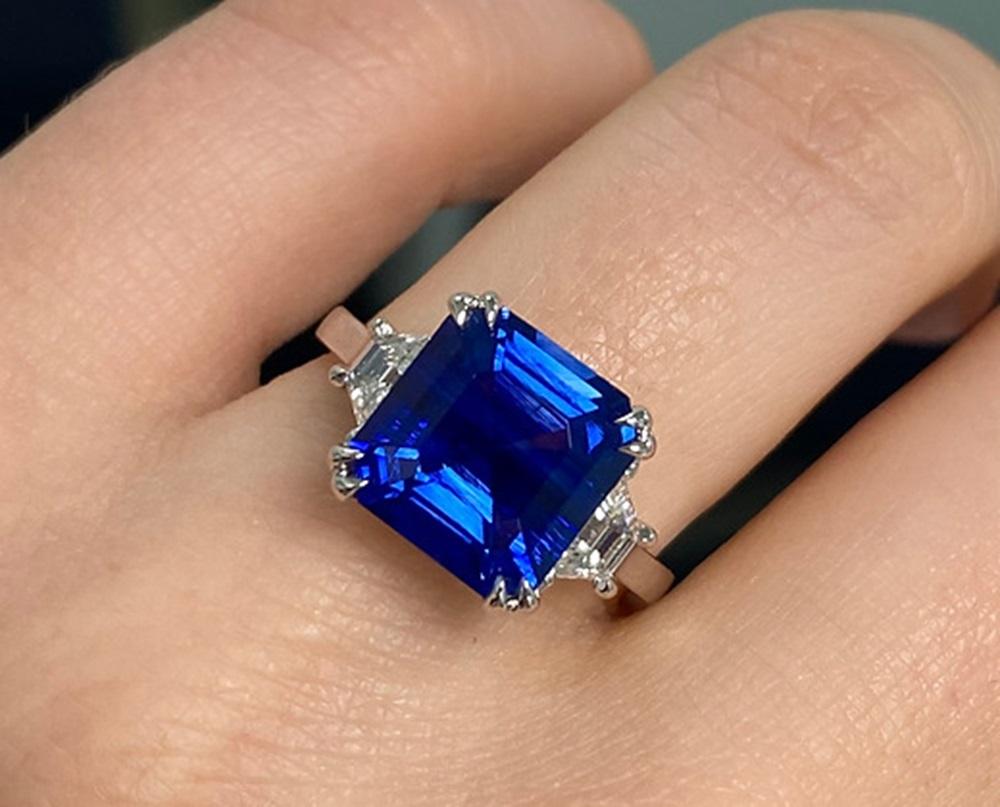 Sapphire Weight: 4.90 CT, Diamond Weight: 0.52 CT, Metal: Platinum, Ring Size: 7, Shape: Emerald-Cut, Color: Blue, Hardness: 9, Birthstone: September, CD Certified