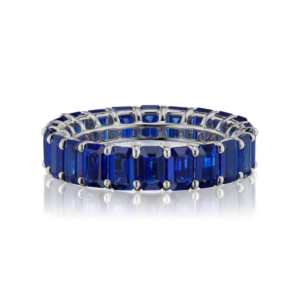 ROYAL BLUE COLOR BLUE SAPPHIRE ETERNITY BAND
A timeless eternity royal blue color blue sapphire band in 18k white Gold with emerald-cut stones around. This design is one for the classics. ( Ring Size 6.5 )
Item:	# 03795
Setting:	18K W
Color