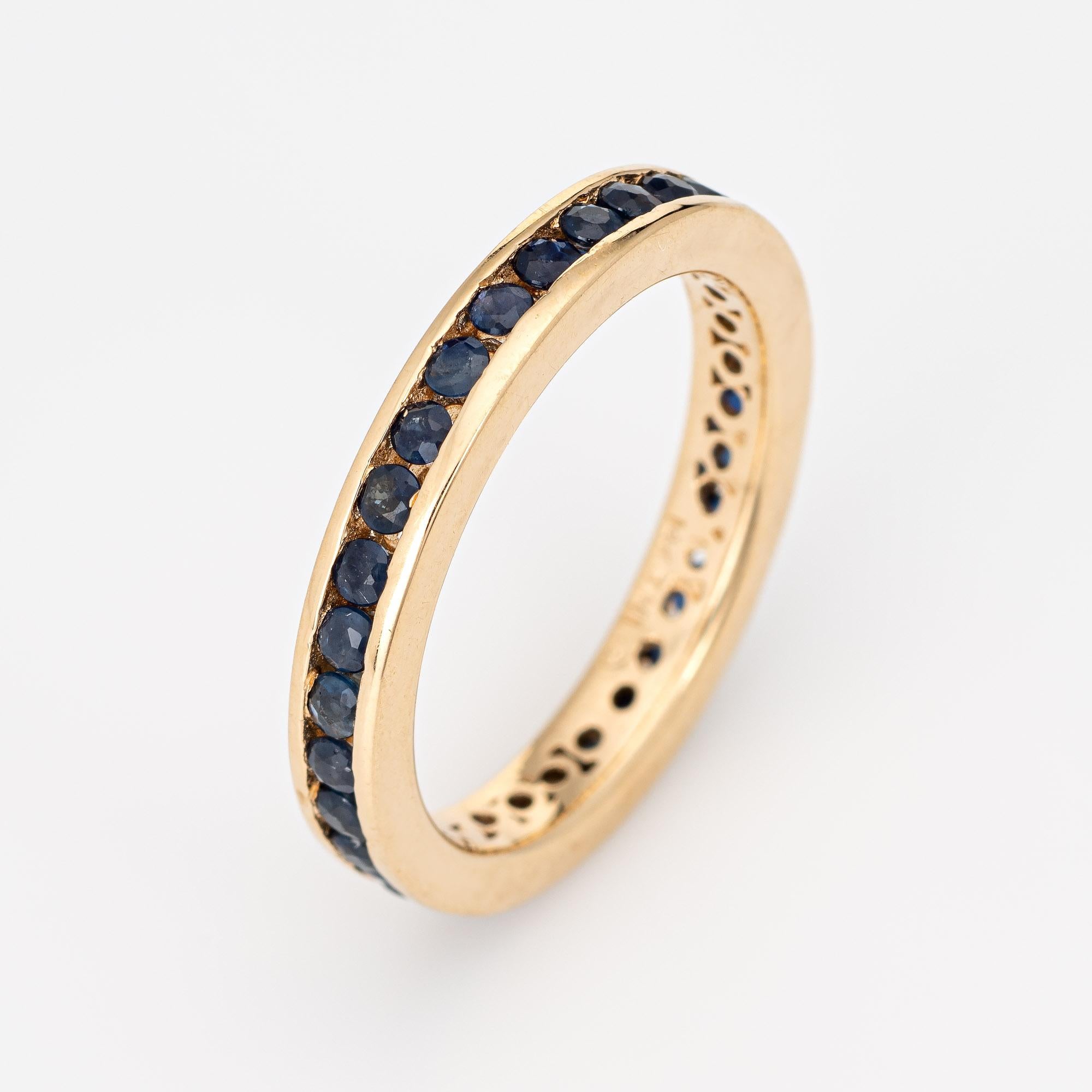 Stylish vintage blue sapphire eternity ring crafted in 14 karat yellow gold. 

34 blue sapphires are estimated at 0.02 carats each and total an estimated 0.68 carats. The sapphires are in excellent condition and free of cracks or chips. 

The