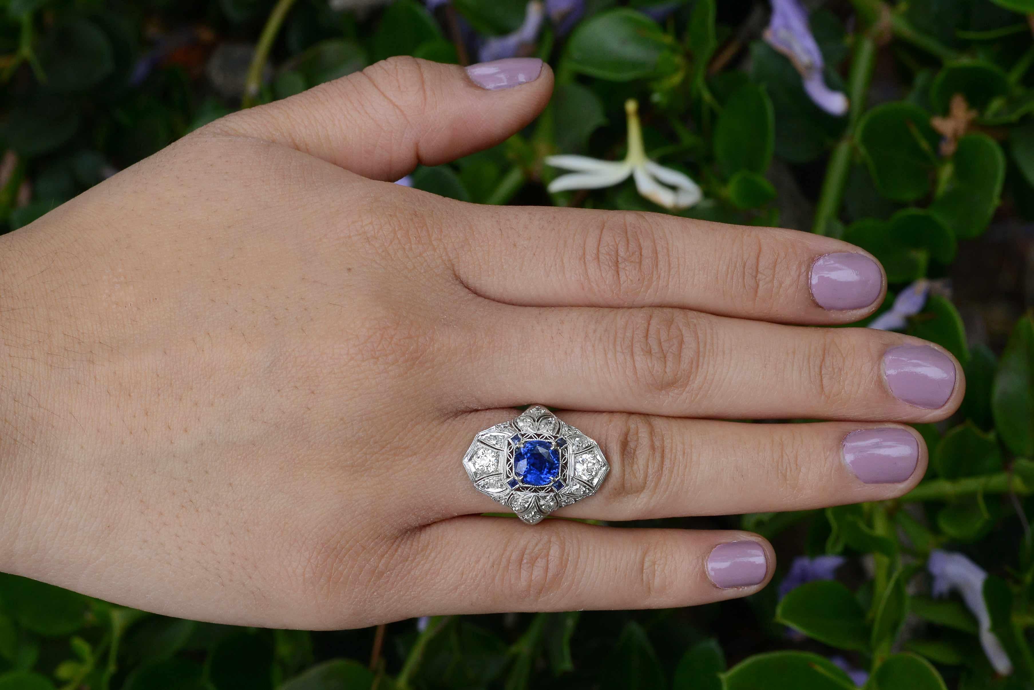 An important natural sapphire engagement ring. Lovingly embedded in the center of the antique platinum filigree is a 2 carat, velvety, rich royal blue sapphire having enormous luster. This Edwardian Art Deco era treasure in a  cocktail, (or dinner