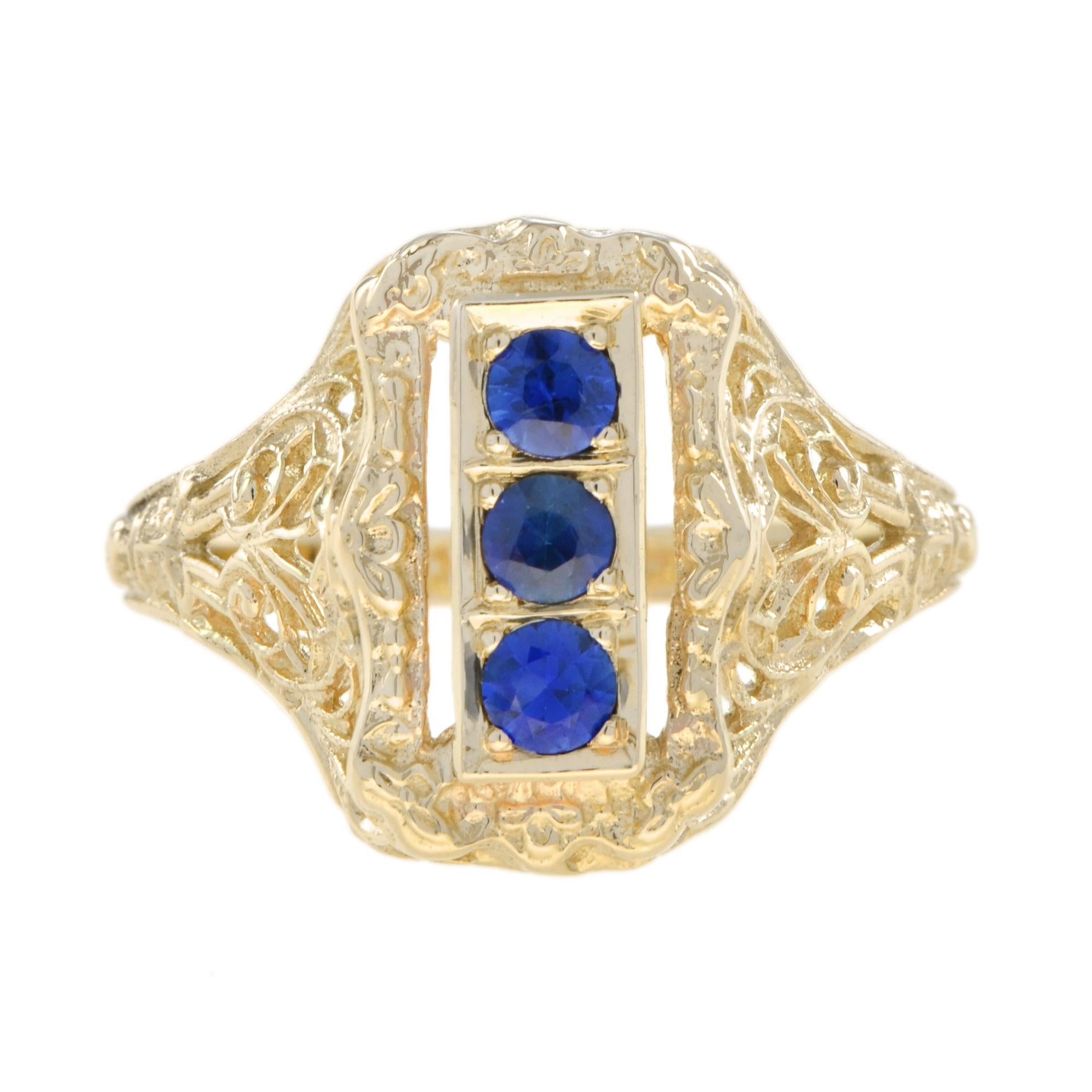 An Art Deco style filigree three stone ring with 2.7 mm. natural blue sapphires in the center. Filigree rings are timeless in style and can be enjoyed, cherished and handed down as precious family heirlooms.

Ring Information
Metal: 14K Yellow Gold