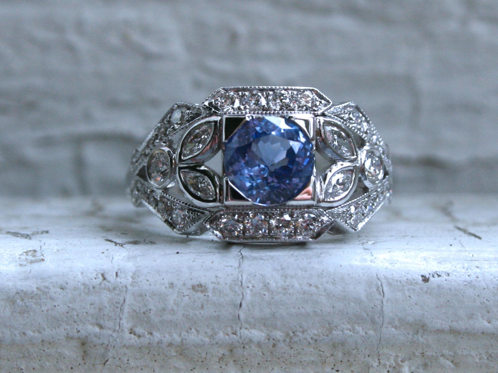 I LOVE the vintage design of this Round Sapphire Floral Diamond Ring Engagement Ring Wedding Ring! Simply stunning, and the sparkle is amazing! The design is a unique vintage floral design, with diamond studded open work, beaded edges, and a