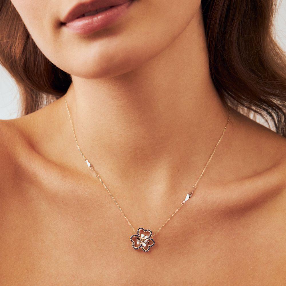 Indulge in the timeless allure of the 14K Solid Gold Sapphire Daisy Necklace by ORENA Jewelry. Every curve and facet of this necklace is lovingly crafted, encapsulating both modern grace and vintage charm. Whether you choose to wear it as a solitary
