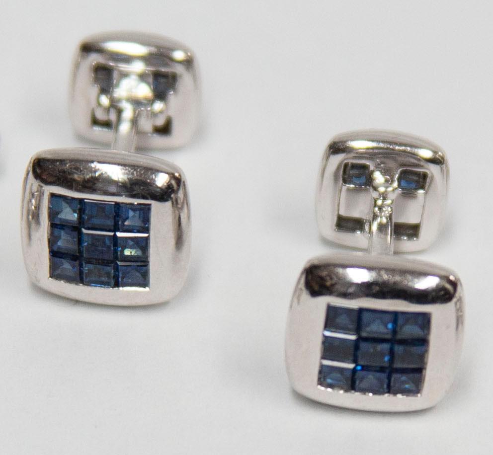 Classic Blue Sapphire Dress Set comprising Pair of Cuff links and four matching Shirt Studs, each centering 9 invisible set square calibrated Sapphires. Marked: 750 (Gold standard for 18K). Hand crafted in 18 Karat white gold. For that Special Man