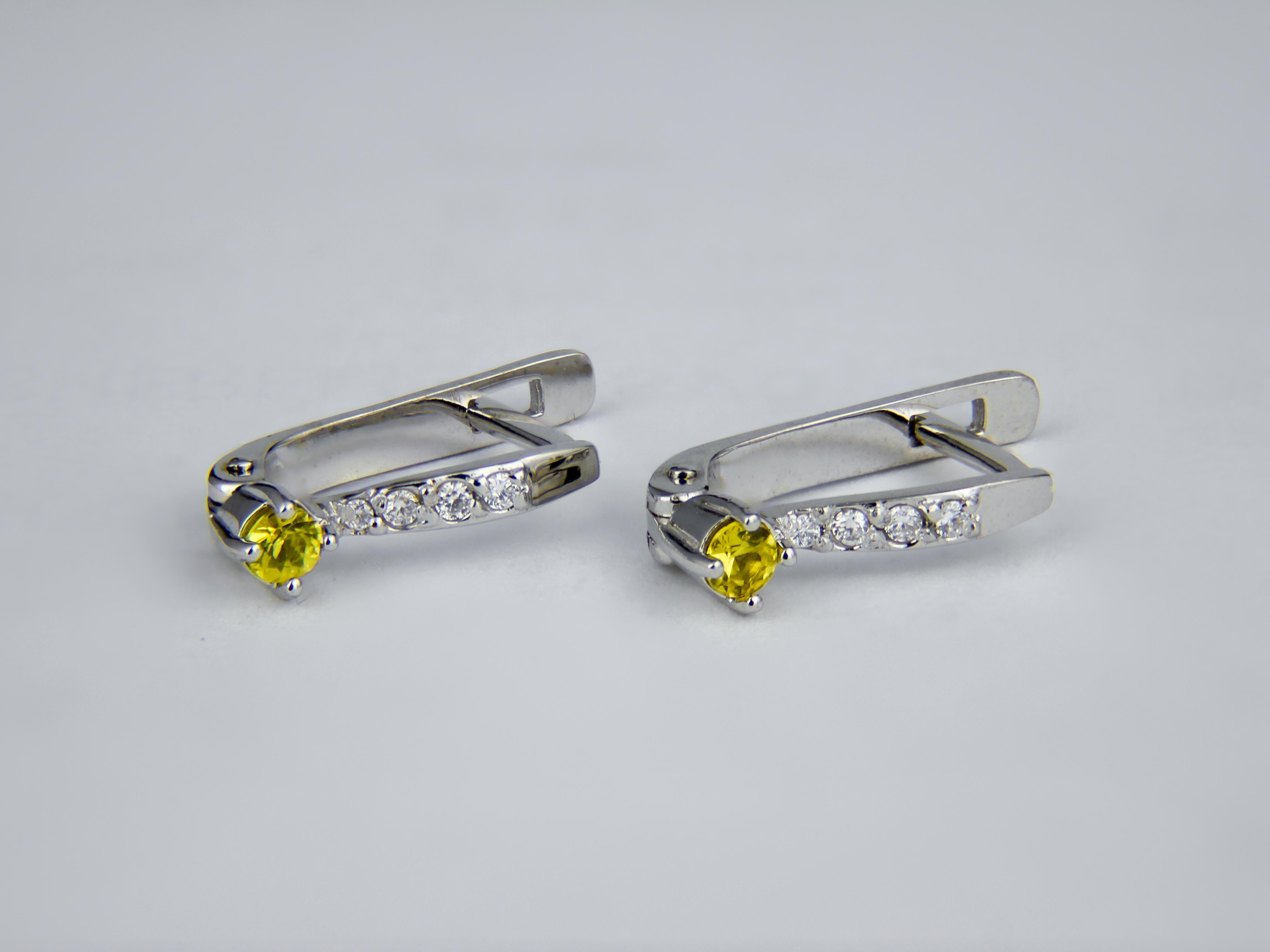 Sapphire gold earrings. 
Tiny yellow sapphire earrings. Gold earrings for girl. Delicate sapphire earrings. Earrings With Sapphire, Diamonds.

Total weight: 2 g. 
Gold - 14k gold
Size: 16.4 x 3.65 mm. 

Central stones: sapphires 
Cut: Round 
Total