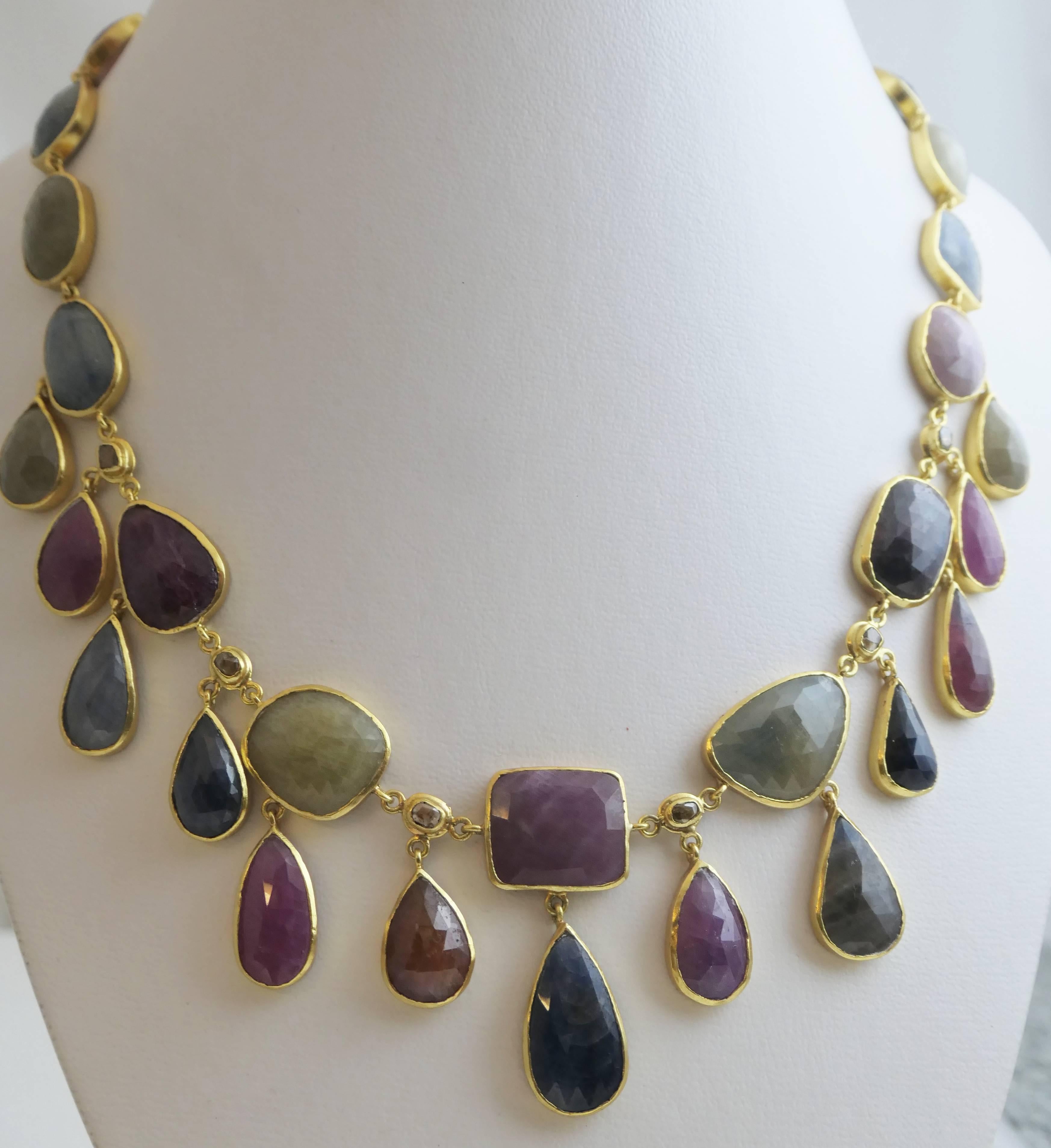 This gorgeous multi color sapphire necklace is 17,5 inches long with an additional 2.2 inch of extension chain and it has a hook clasp. The central drop measures approximately 4.4 cm in depth. The sapphire gemstones are all faceted and varying