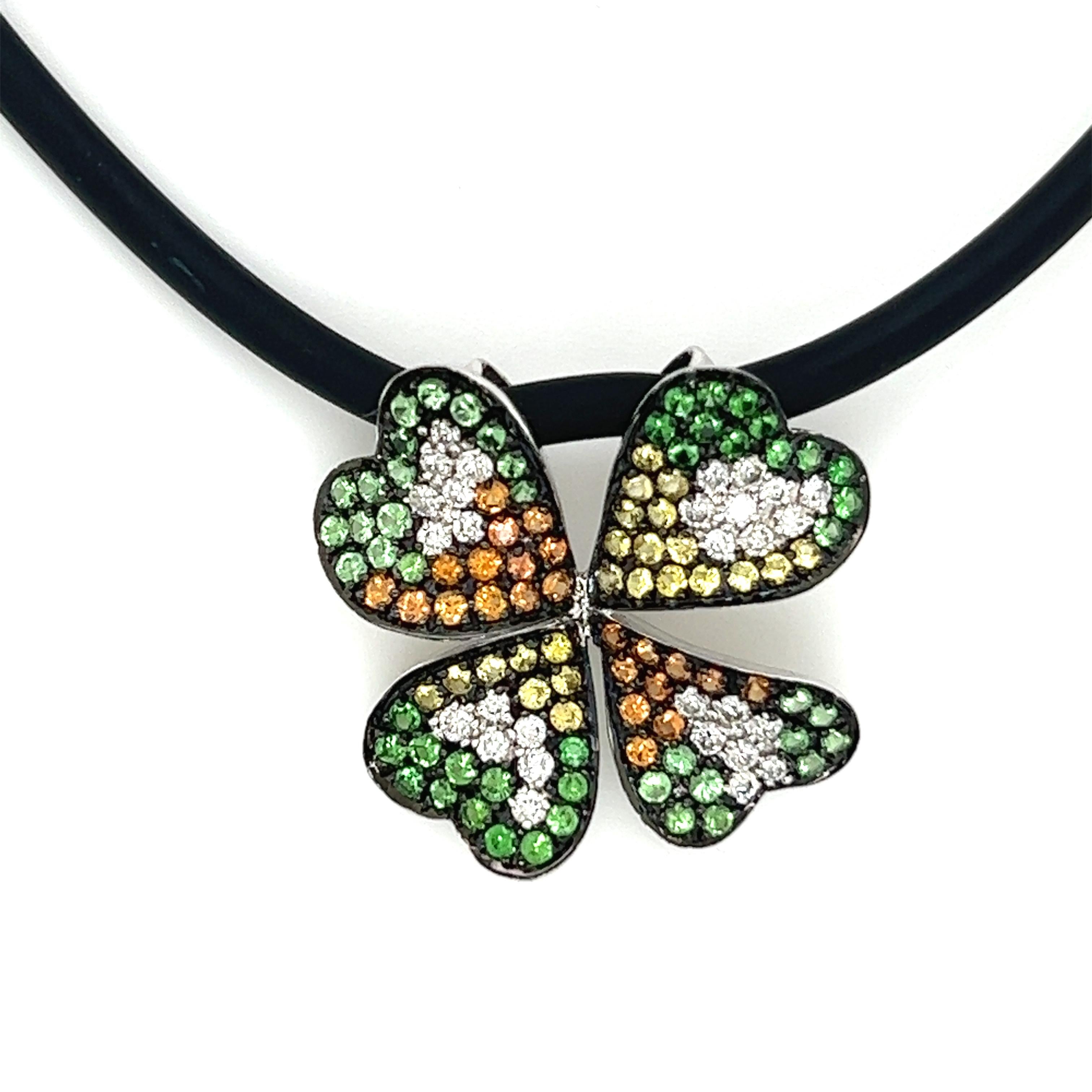 I love this fun 4 leaf clover necklace. It has yellow and orange sapphires and green garnets with a total carat weight of 1.51cts and .48cts of white diamonds, G color, VS2 clarity set in 14k white gold on a casual rubber cord. 