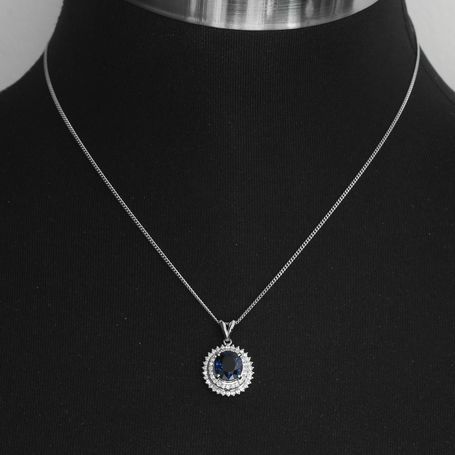 Sapphire Halo and Diamond on Platinum Mounting Necklace  - Round Sapphire weighing 2.69 cts. surrounded by .49 cts of diamond set in platinum. Necklace length 16 inches. Pendant  measures 1/2 inch. .