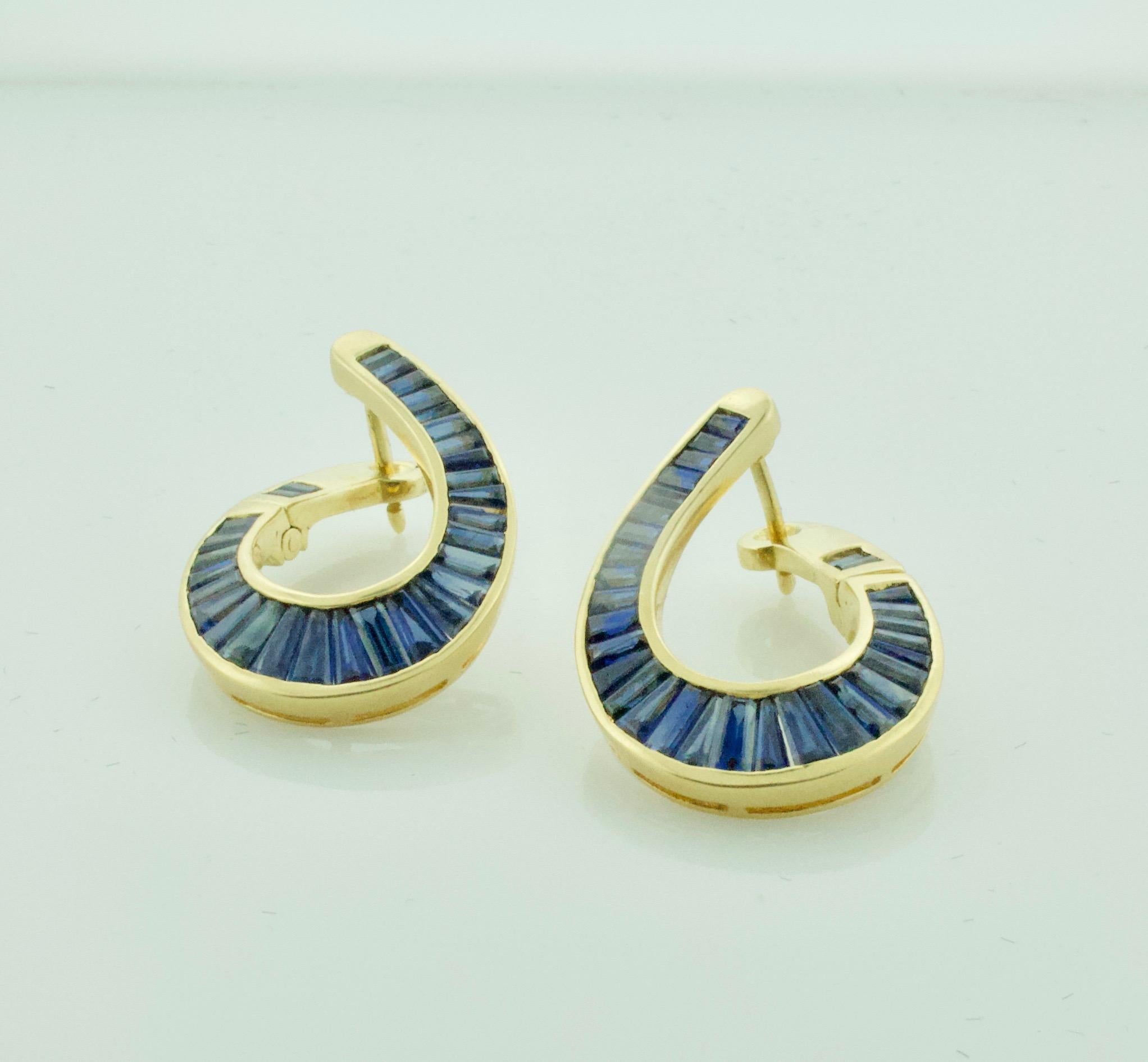 Sapphire Hoop Earrings in 18k Yellow Gold 4.00 carats

Sixty Tapered Baguette Cut Sapphires Weighing 4.00 Carats Approximately [bright with no imperfections visible to the naked eye]

Handmade Left and Right.  You decide which is which.