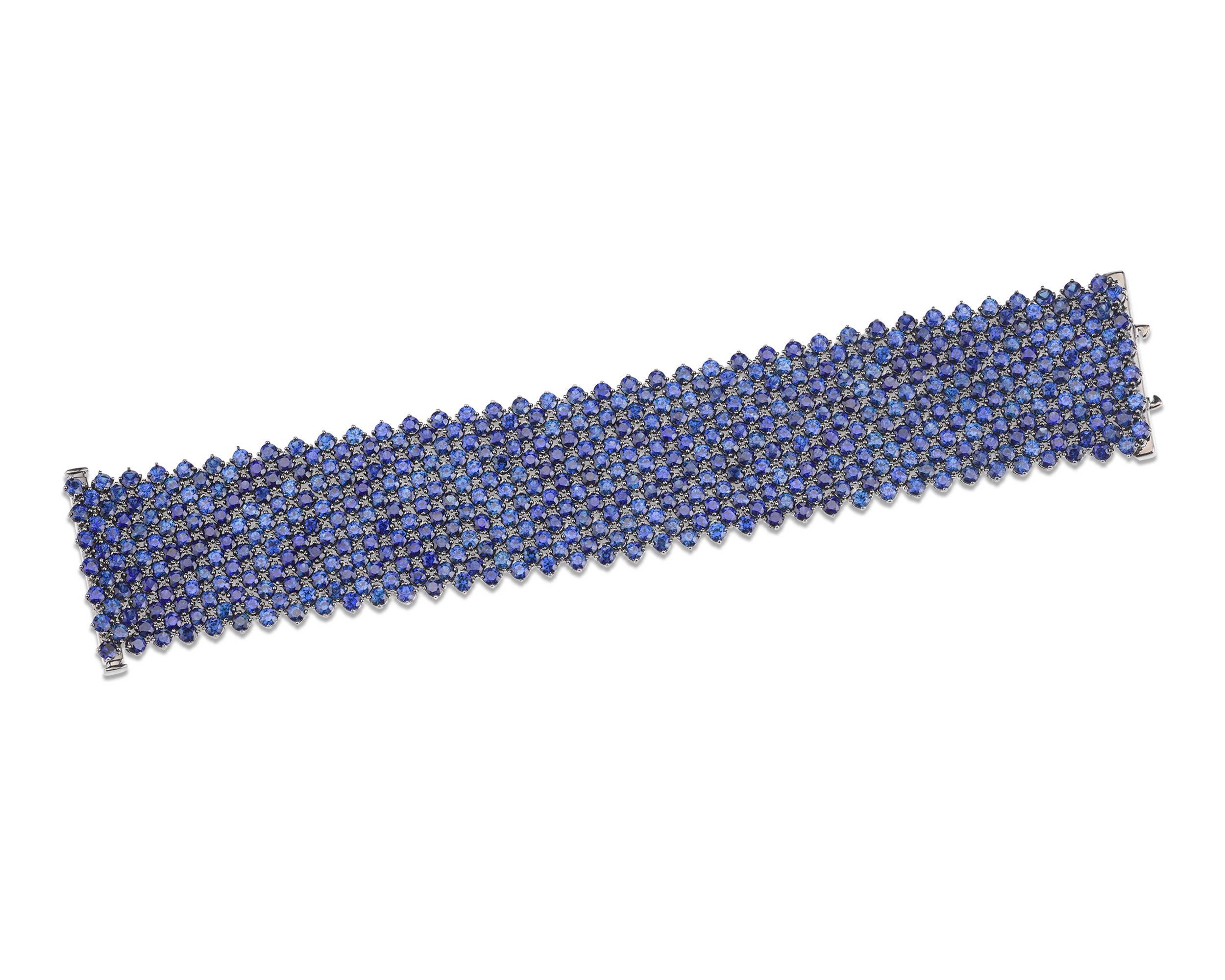 The 494 velvety-blue sapphires in this alluring bracelet cascade like water around the wrist. Certified by C. Dunaigre, the remarkable jewels weigh 66.58 total carats and boast an absolutely remarkable color. The stunning bracelet’s extraordinary