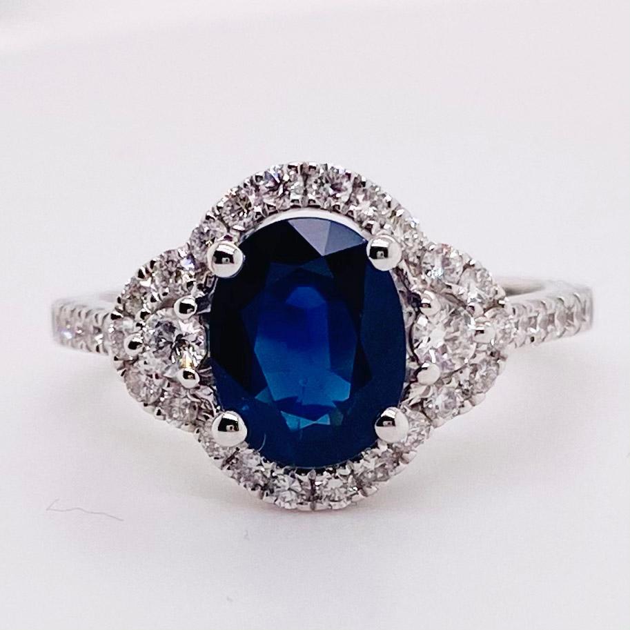 This sapphire ring is stunning! With an oval natural, genuine sapphire in the center and surrounded by a diamond halo and diamonds on the band.  This is a great ring for an engagement ring or a right hand ring. A sapphire is the traditional gemstone