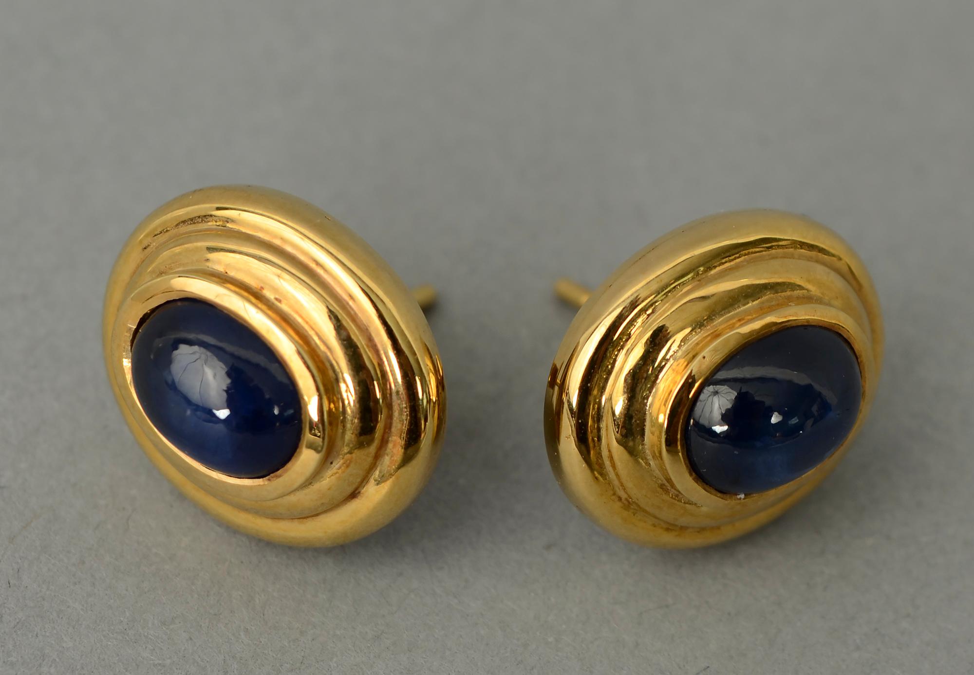 Delicate gold and sapphire earrings. Each earring has a cabochon sapphire that measures 1/4