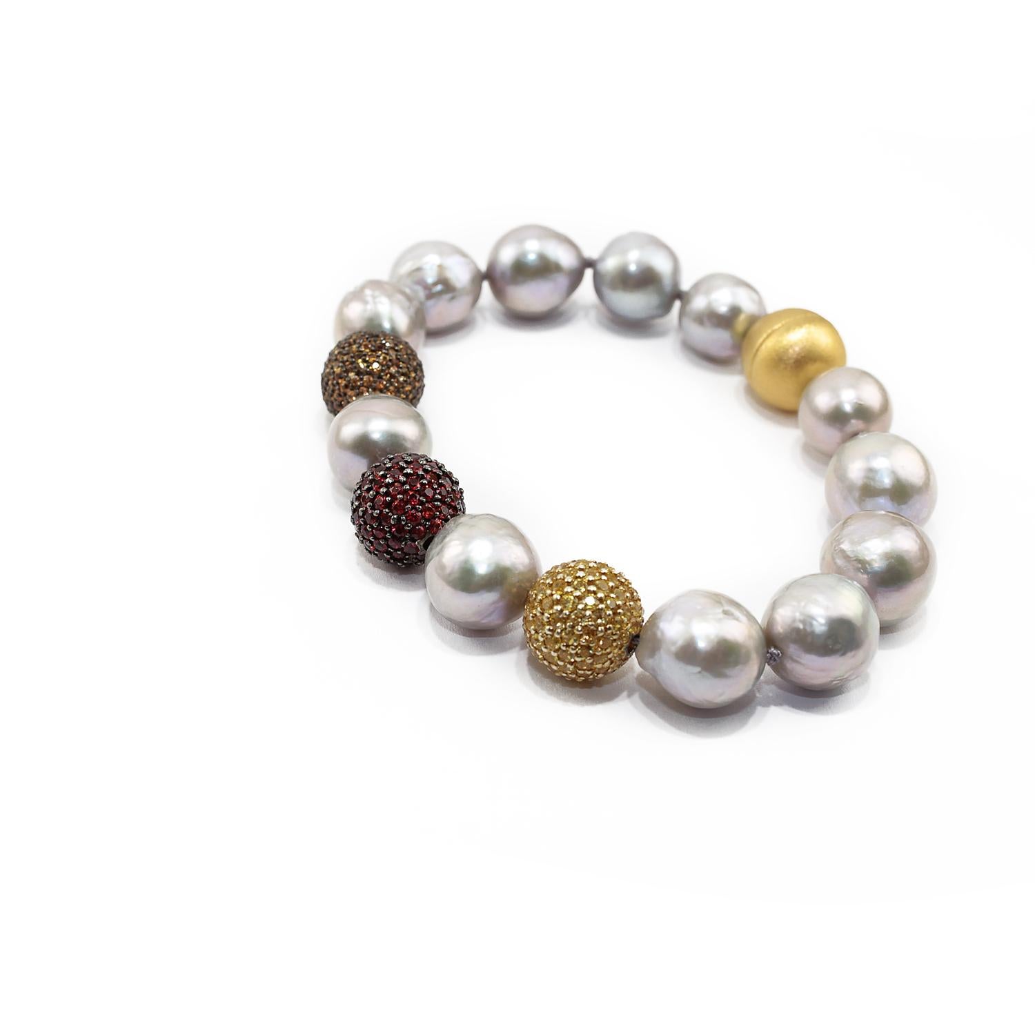 Nice bracelet made up of light and dark orange sapphires and yellow sapphires pave on silver setting, baroque grey pearls and 925 satin silver clasp. 
Sapphires pave ct. 1,79 each 
Yellow sapphires ct. 1,79
Baroque grey pearls
925 satin yellow
