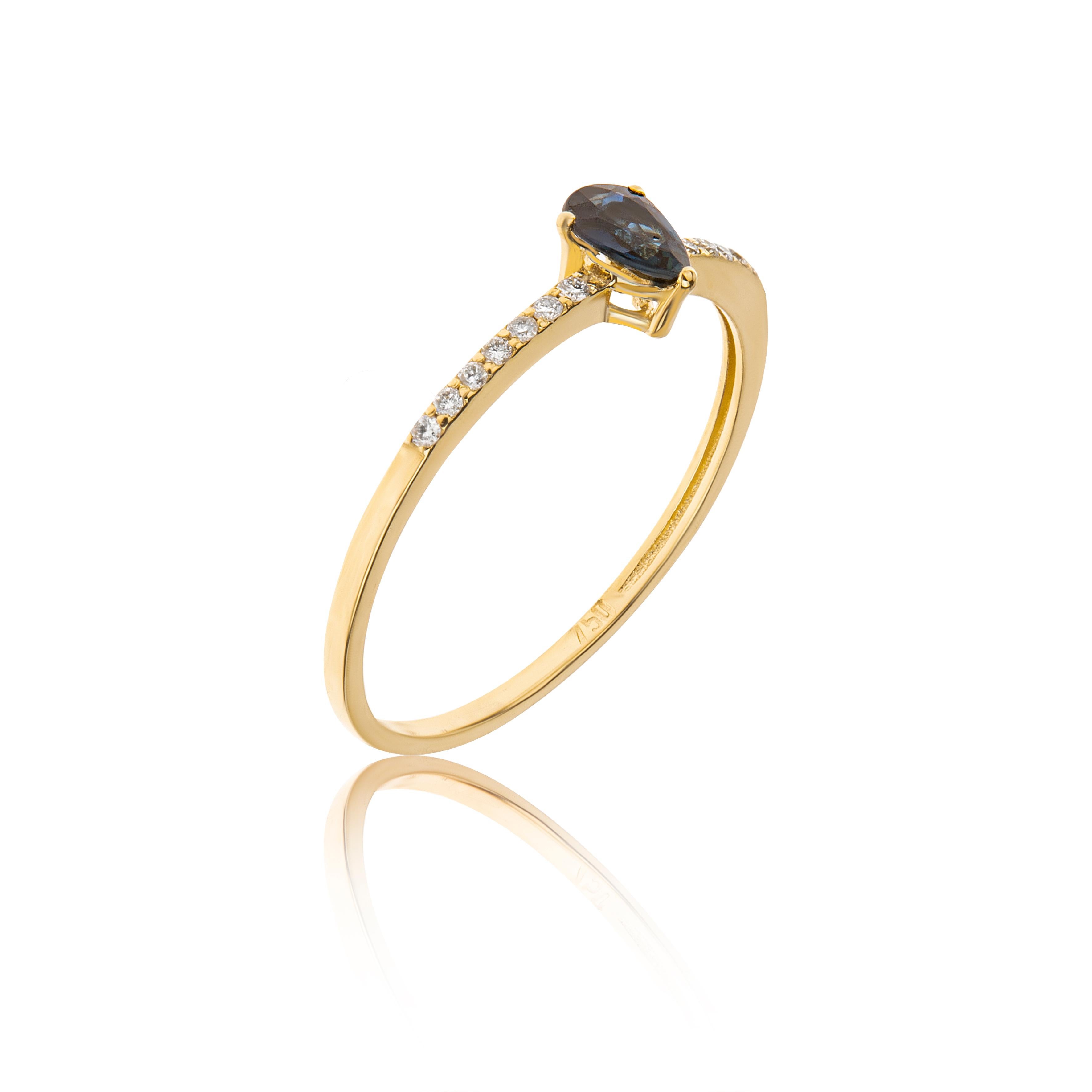 Sapphire Pear Cut Stackable Ring with Diamonds Brilliant Cut in 18Kt Yellow Gold
The ring is hand made in 18Kt yellow gold. The main stone in the center is a sapphire 0.28ct pear cut. On the sides of the ring, white diamonds are set in pave style,