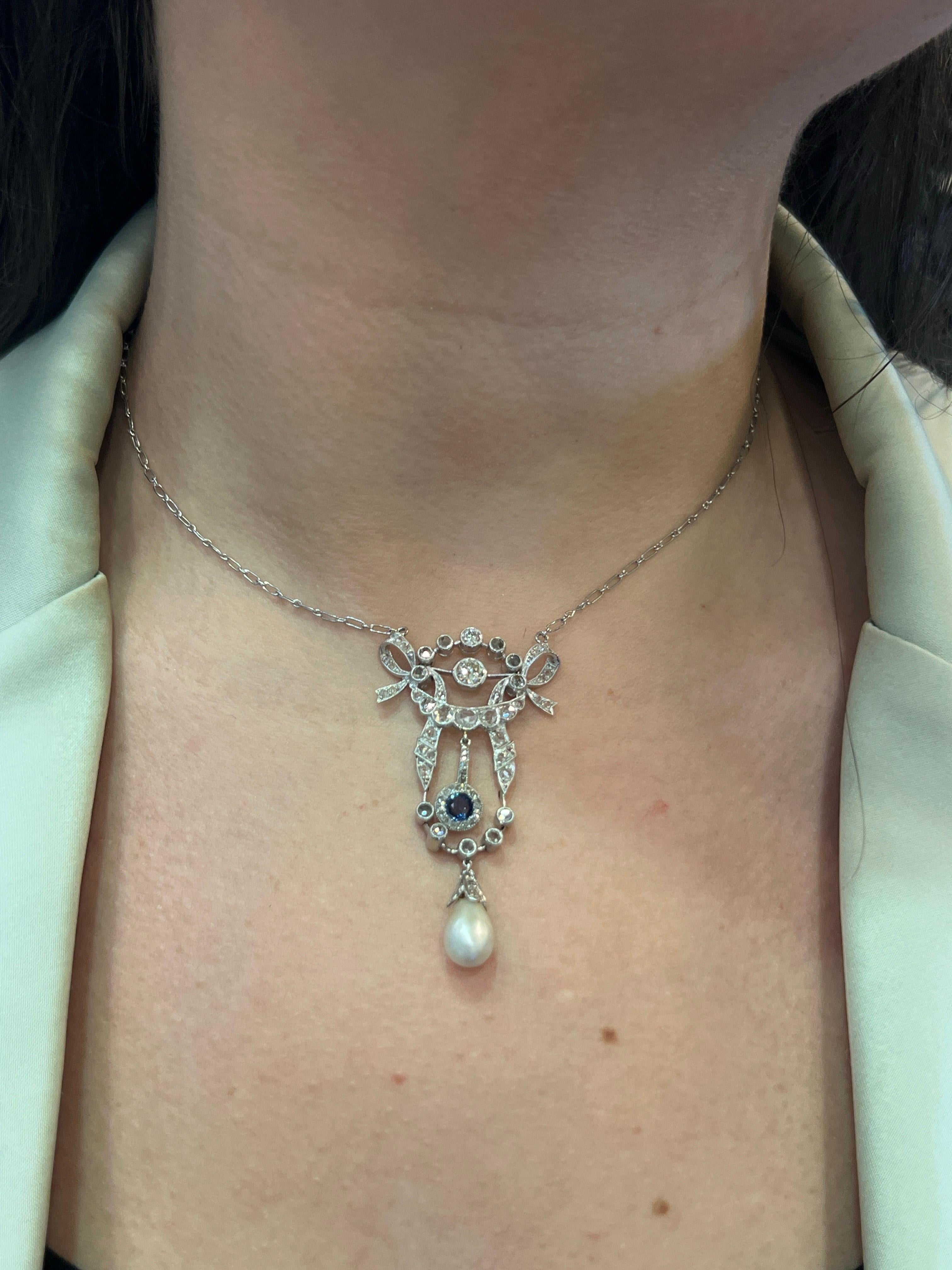 Sapphire Pearl and Diamond Pendant Necklace 

 A white gold pendant necklace set with a round cut sapphire, a pearl drop, and diamonds. 

Approximate Length:  15.5 inches
Metal Type: 14-karat gold