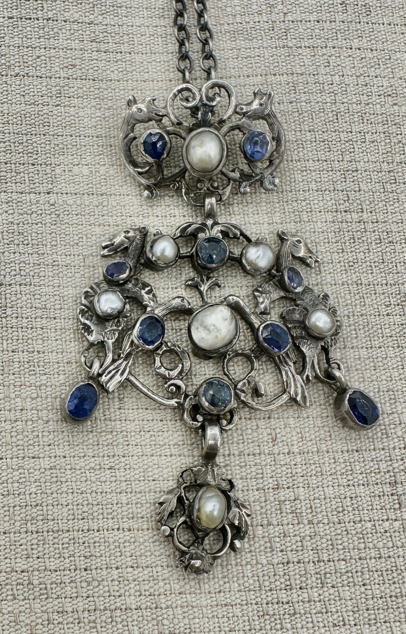 This is a magnificent Austro-Hungarian Sapphire and Pearl Pendant Necklace with animal, bird, horse, deer and flower and leaf motifs.  It is in the Renaissance Revival style in Silver and dates to circa 1870.  The rare necklace has three articulated