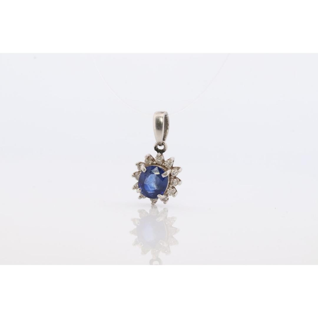Vintage from the 1990s
Materials: Gold, Platinum

Gemstone: Sapphire

Stunning Sapphire and Diamond Halo Pendant.

Natural Sapphire. Halo set diamonds

Platinum 900 Setting.

Condition: Shows minimal signs of wear. Tiny