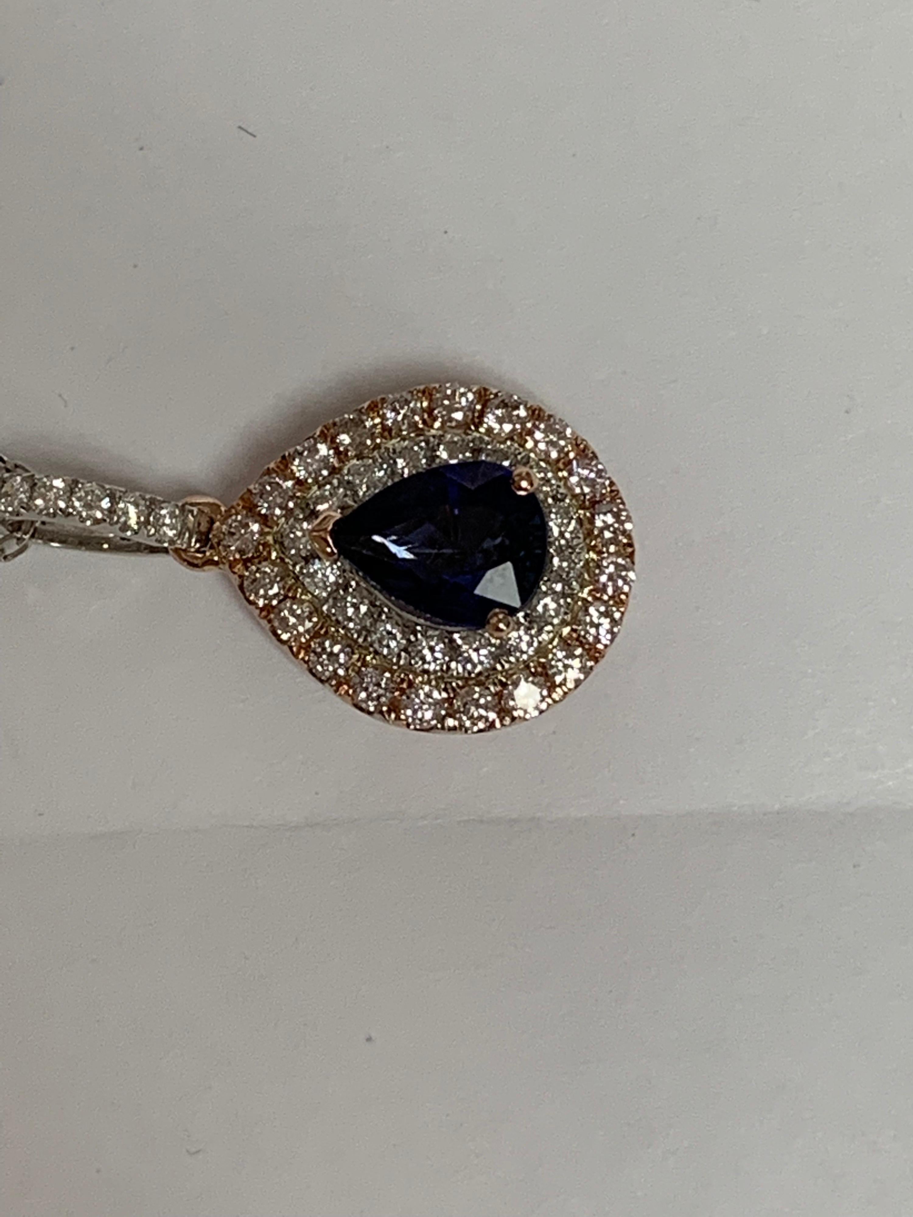 Natural 1.52 Carat Pear shape blue sapphire with 0.21 Carat round white and 0.39 Carat round pink diamonds set in 14 Karat two tone gold is one of a kind hand crafted pendant,