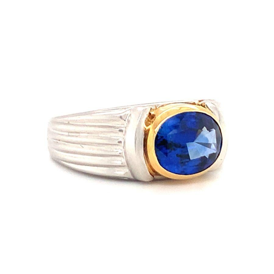 One sapphire platinum and 18K yellow gold ring centering one gold bezel set, oval brilliant cut sapphire weighing approximately 3.25 ct. with contemporary ribbed platinum satin finish mount.

Daring, scintillating, powerful.

Additional