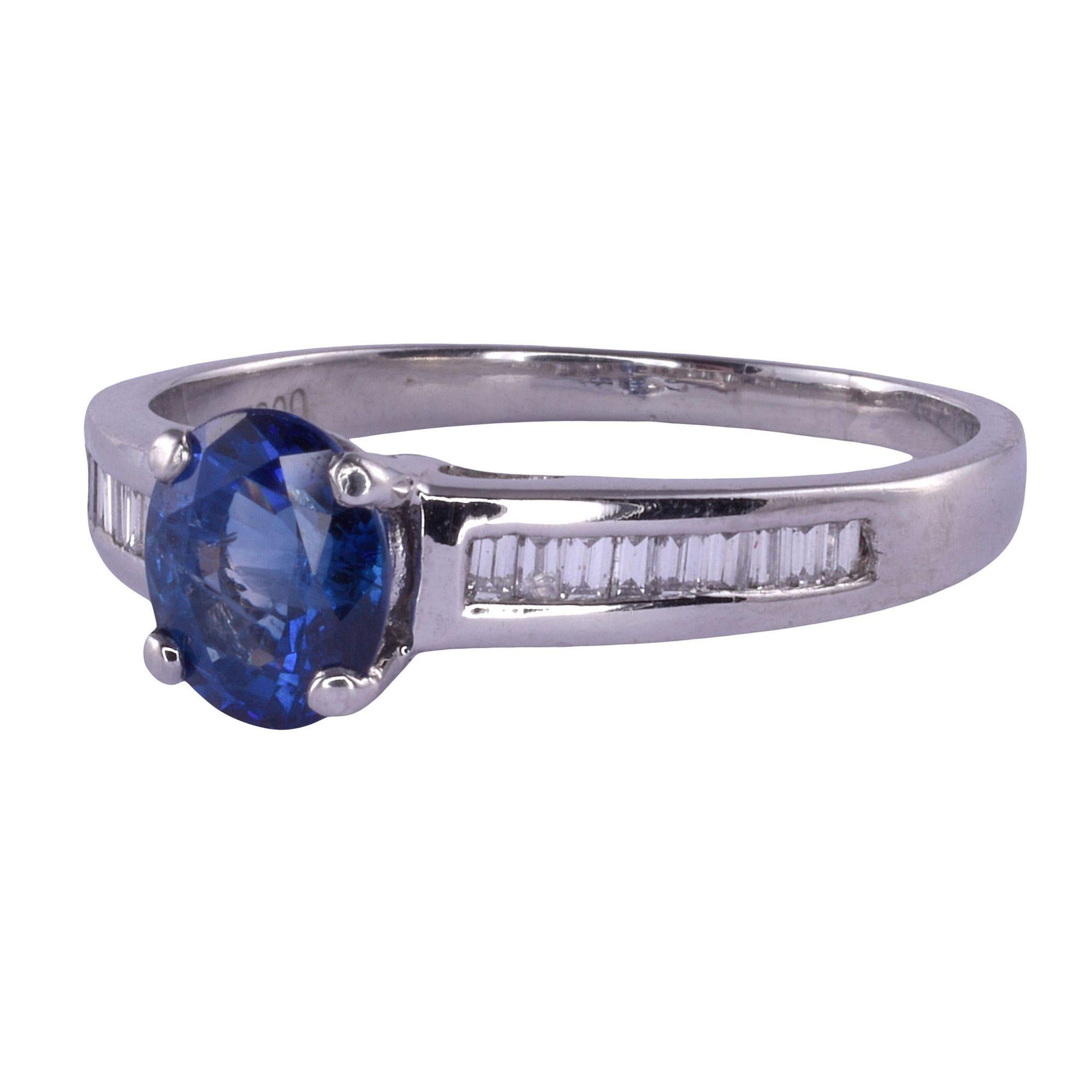 Estate sapphire platinum ring. This platinum ring features a 1.40 carat sapphire with a channel of baguette diamonds on each side. There are .30 carat total weight of diamonds having VS1 clarity and G-H color. This sapphire ring is a size 9. [KIMH
