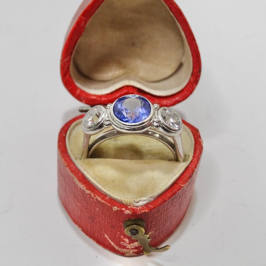 Wow! Do not miss out on this absolutely stunning blue sapphire and diamond ring circa 1950s! A forged platinum ring is set with a 2 carat 7.9x7.7mm oval faceted blue sapphire and a pair of round brilliant diamonds, 1.06 carrat total weight, clarity