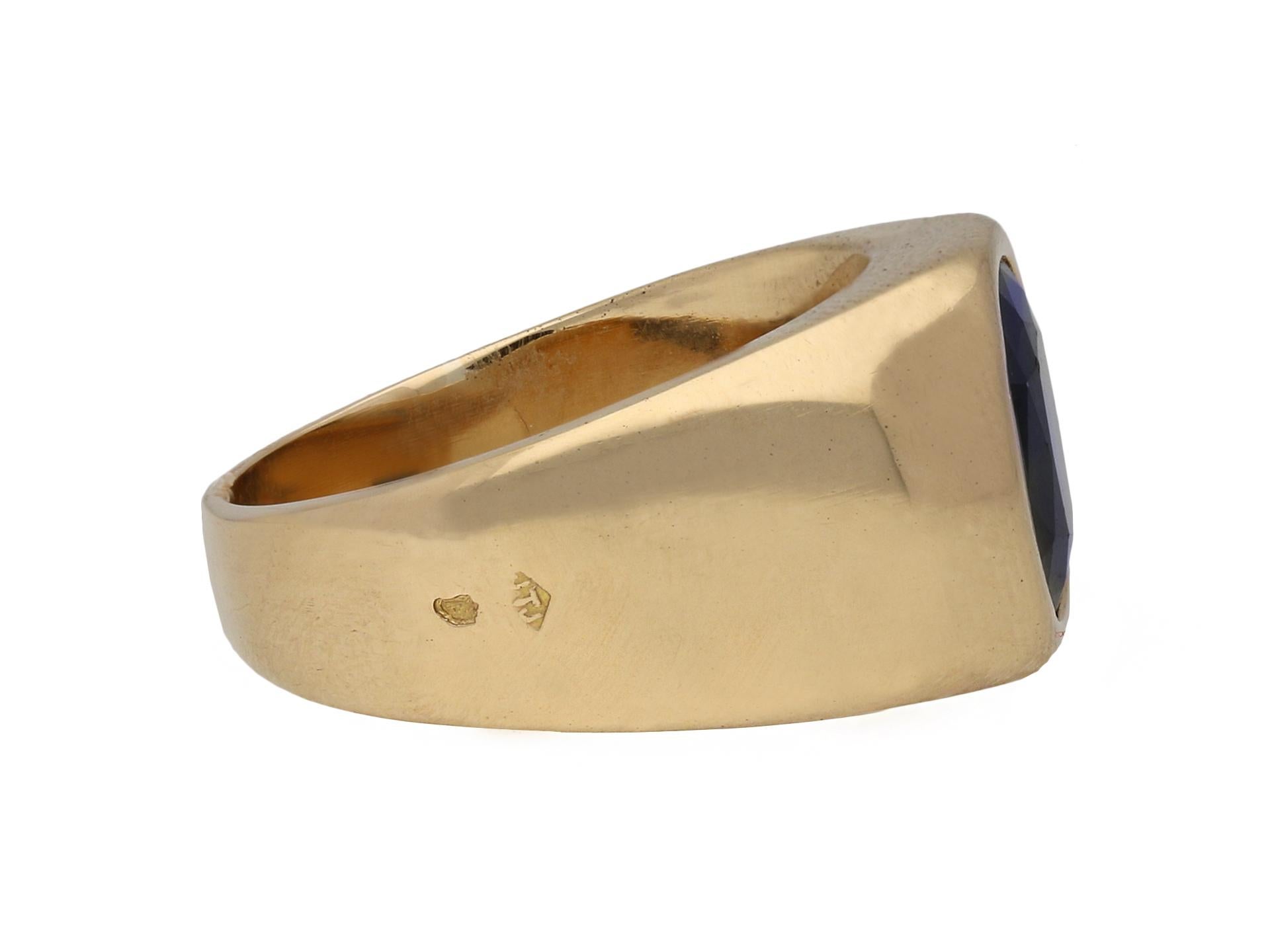 Vintage sapphire solitaire dress ring. Centrally set with a cushion shape old cut natural unenhanced sapphire in an open back rubover gypsy setting with an approximate weight of 3.20 carats, to an impressive dress ring set with polished edges, a