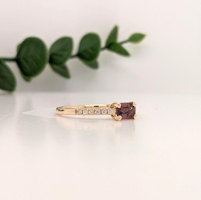 This dainty inspired ring features a stunning vibrant wine colored sapphire in 14K yellow Gold with diamond accents. This staple ring makes for a stunning accessory to any look!

A fancy ring design perfect for an eye catching engagement or