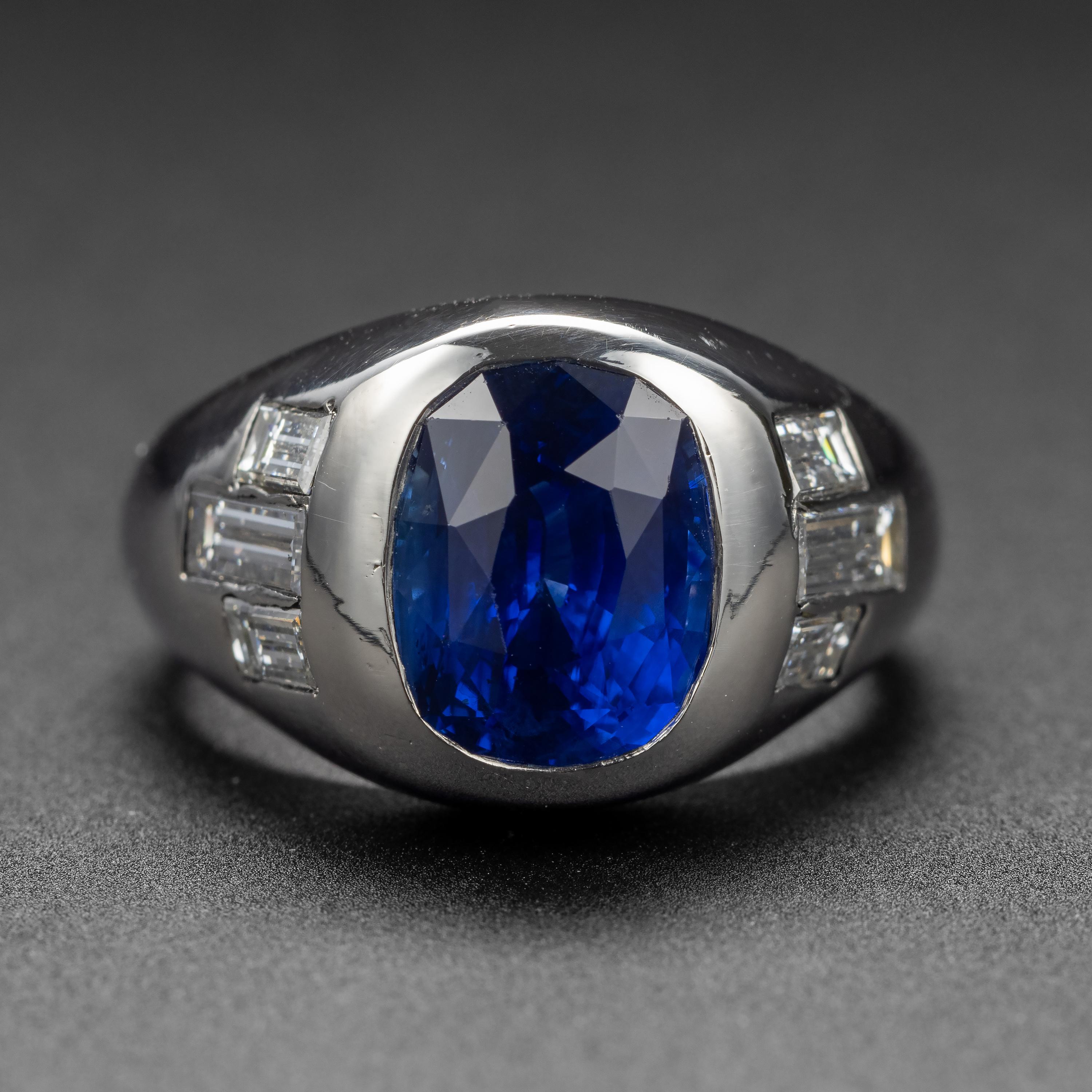 This sleek and impressive ring is the very epitome of Mid-century style. Originally created for a man, this ring could obviously be worn by anyone who appreciates the sleek, aerodynamic lines and vivid royal blue of the gem. 

This certified